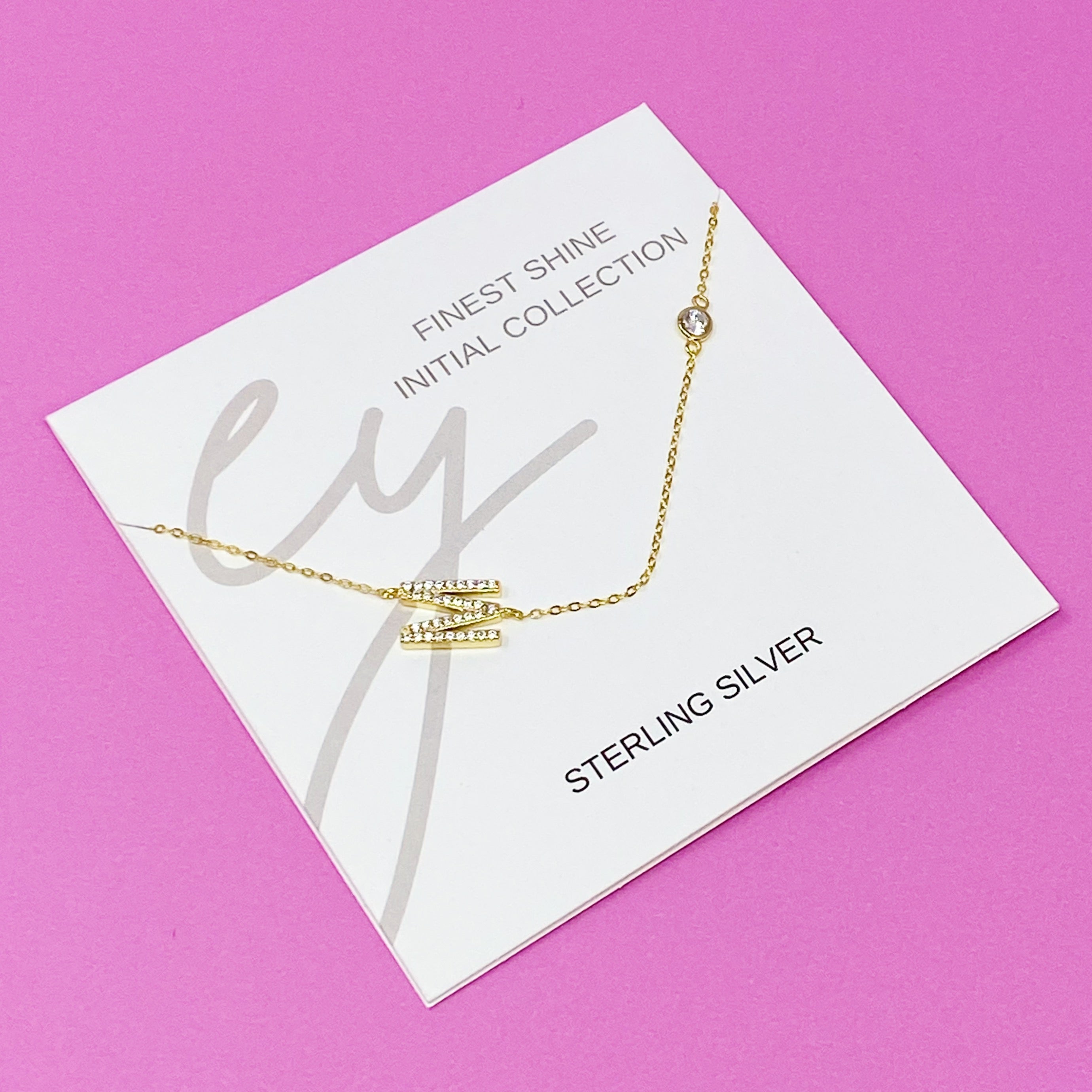 Finest Shine Initial Sterling Silver Necklace featuring a dainty chain, side hanging initial charm, and small cubic zirconia for added sparkle.