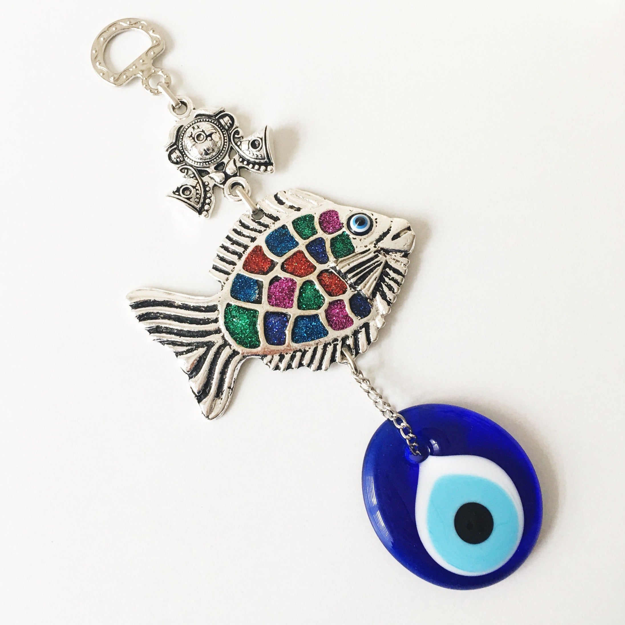 A beautiful Fish Evil Eye wall hanging featuring a fish charm and blue evil eye bead, symbolizing protection and good luck.