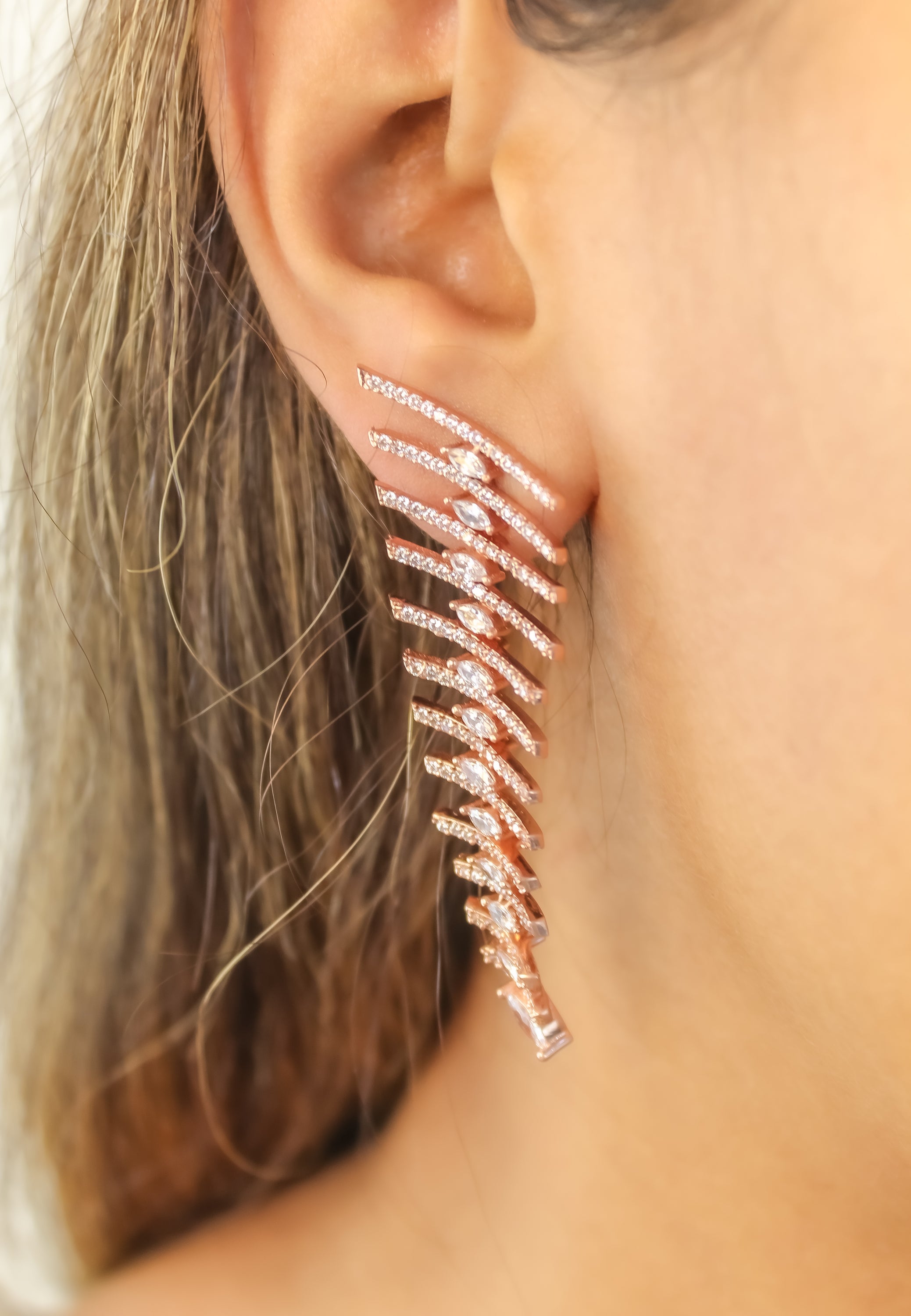 Elegant Fishbone Earrings in gold, silver, and rose-gold plating with zirconia stones, showcasing a modern design.