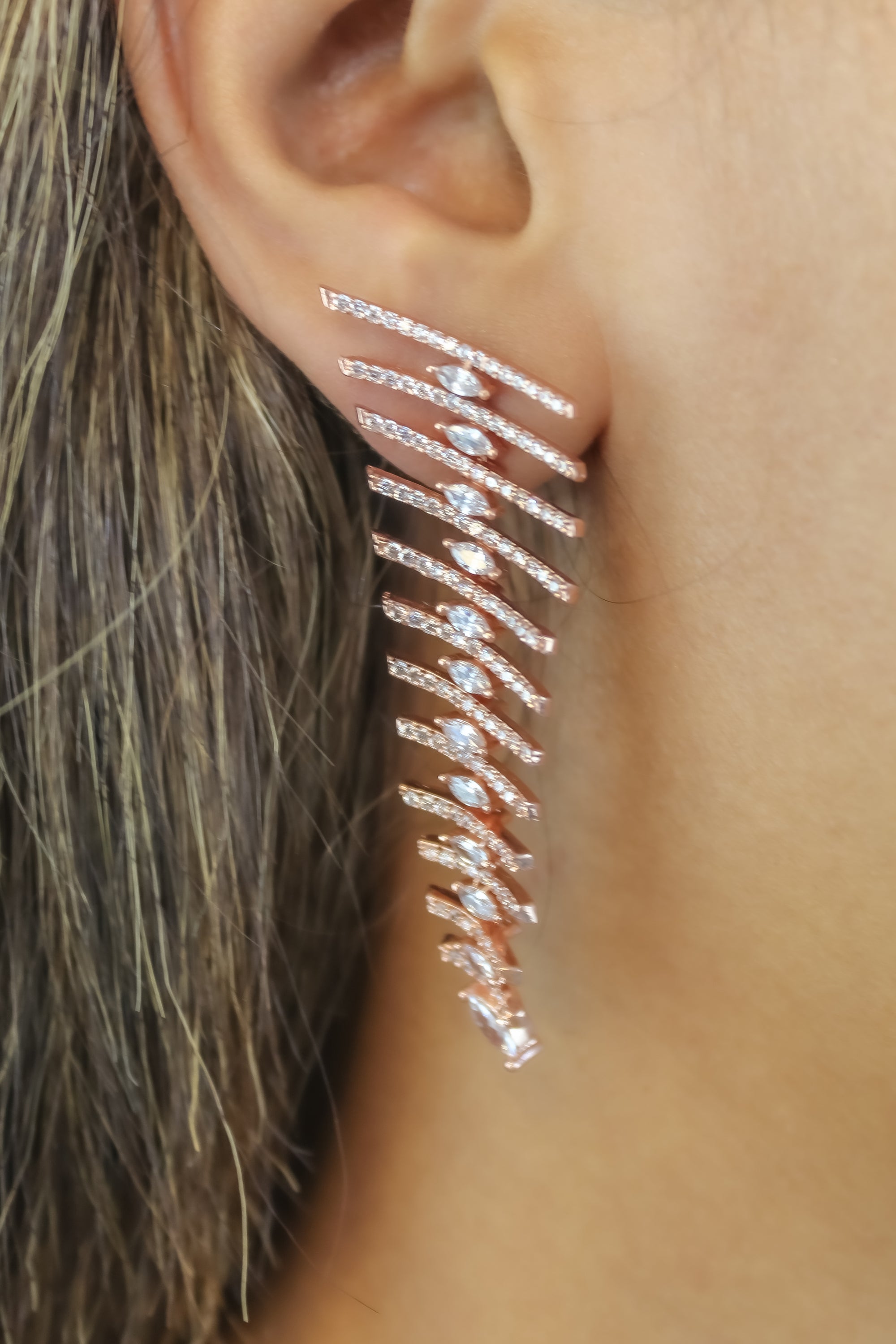 Elegant Fishbone Earrings in gold, silver, and rose-gold plating with zirconia stones, showcasing a modern design.