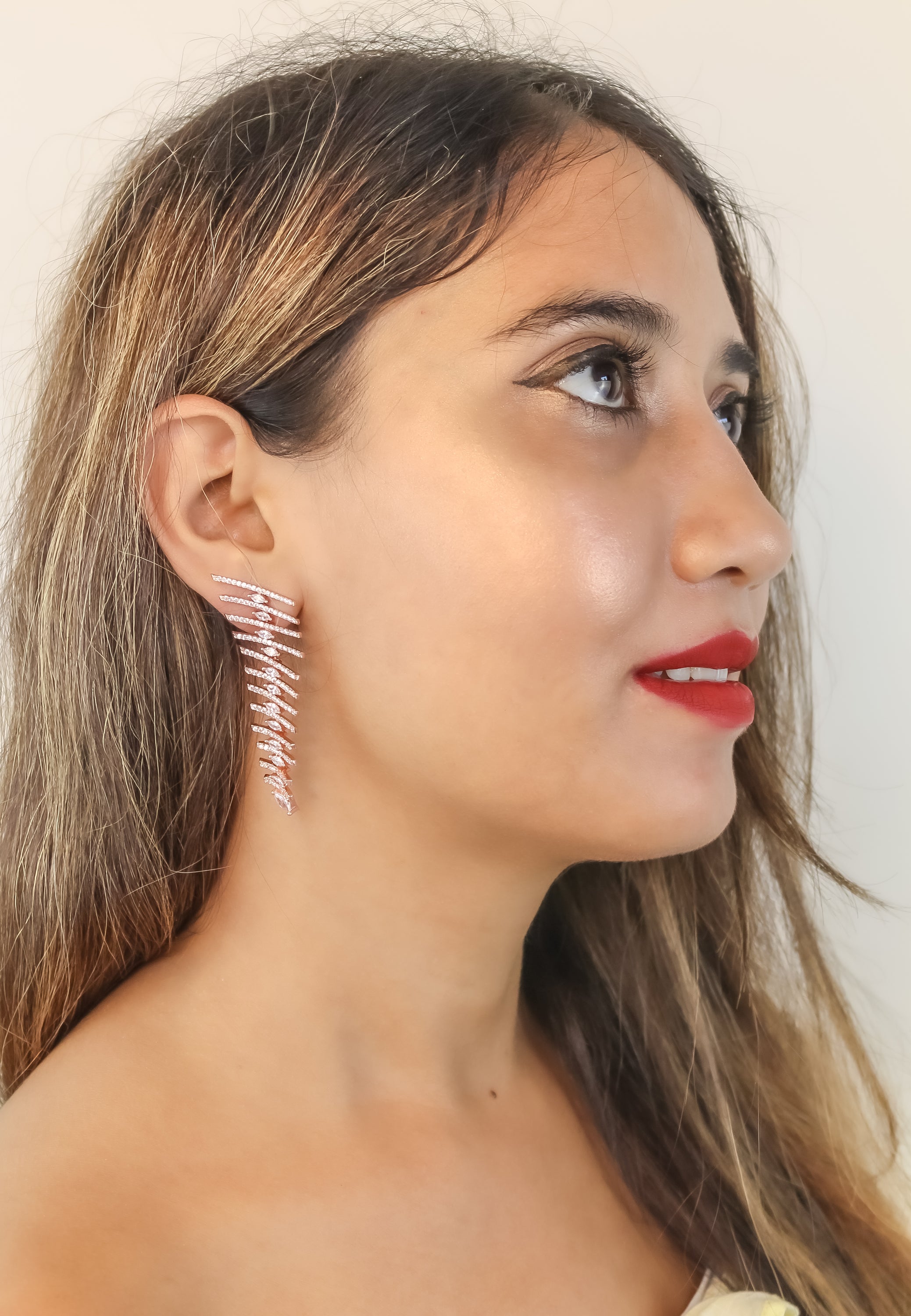 Elegant Fishbone Earrings in gold, silver, and rose-gold plating with zirconia stones, showcasing a modern design.