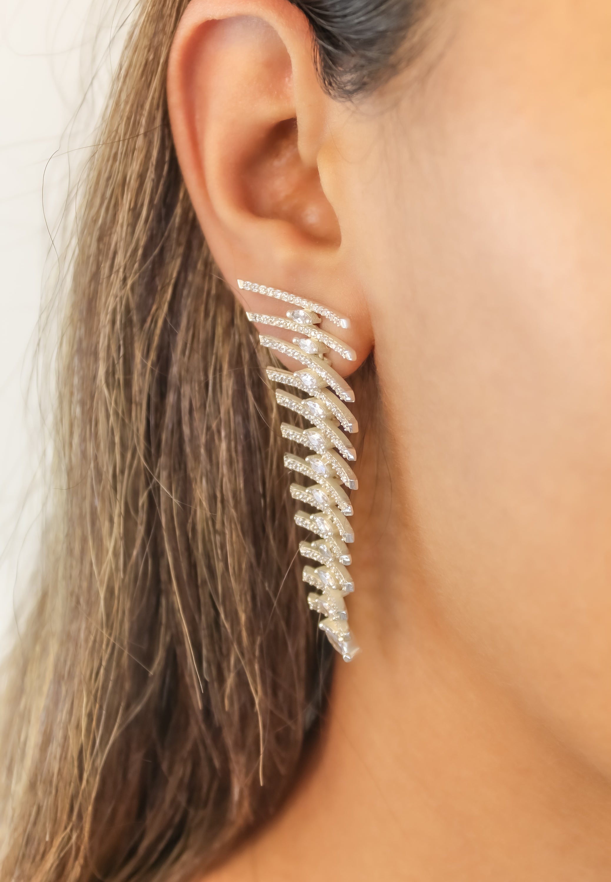 Elegant Fishbone Earrings in gold, silver, and rose-gold plating with zirconia stones, showcasing a modern design.