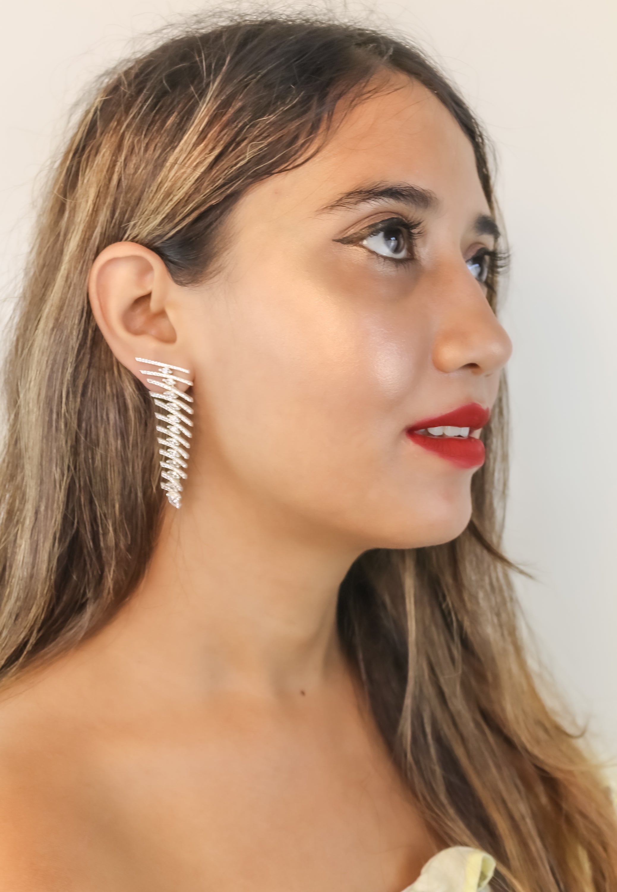 Elegant Fishbone Earrings in gold, silver, and rose-gold plating with zirconia stones, showcasing a modern design.