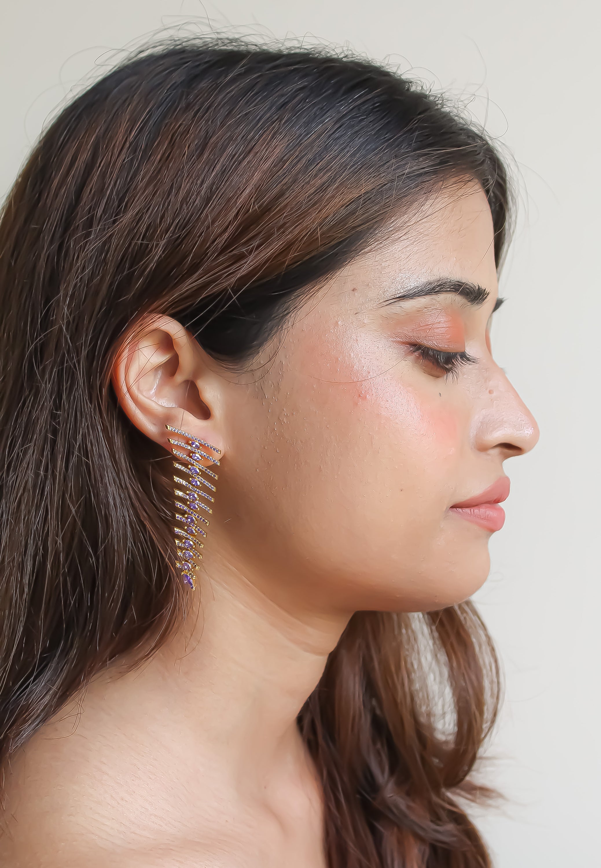 Elegant Fishbone Earrings in gold, silver, and rose-gold plating with zirconia stones, showcasing a modern design.