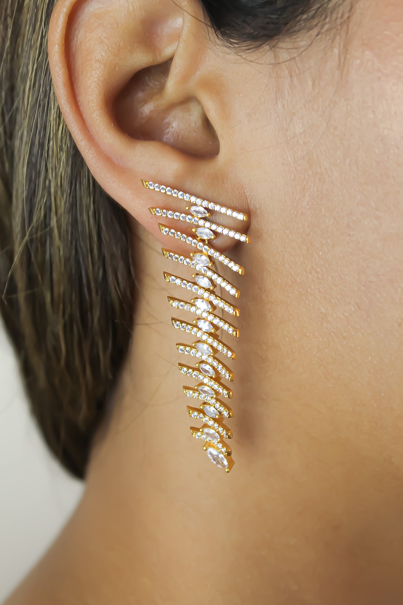 Elegant Fishbone Earrings in gold, silver, and rose-gold plating with zirconia stones, showcasing a modern design.