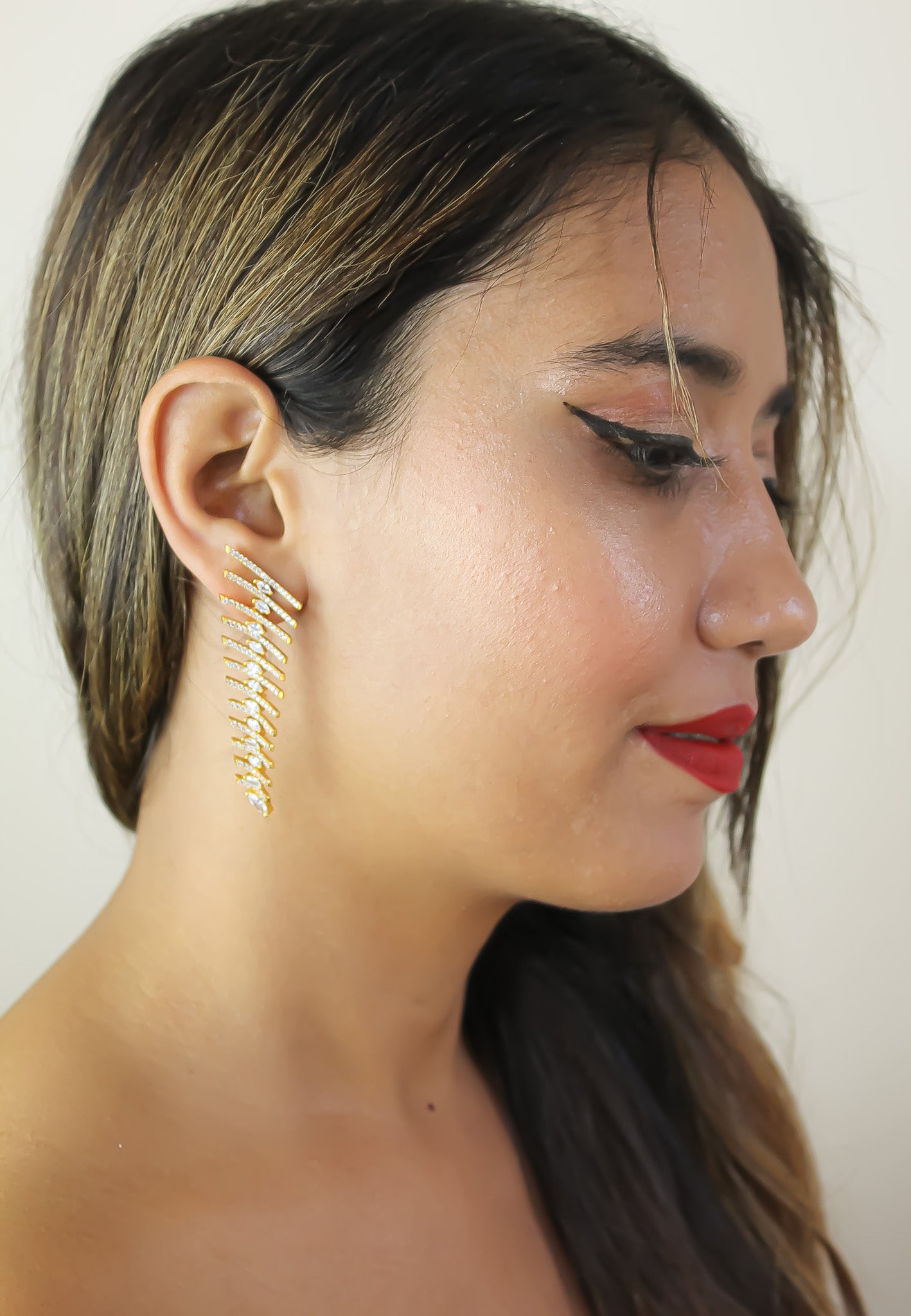 Elegant Fishbone Earrings in gold, silver, and rose-gold plating with zirconia stones, showcasing a modern design.