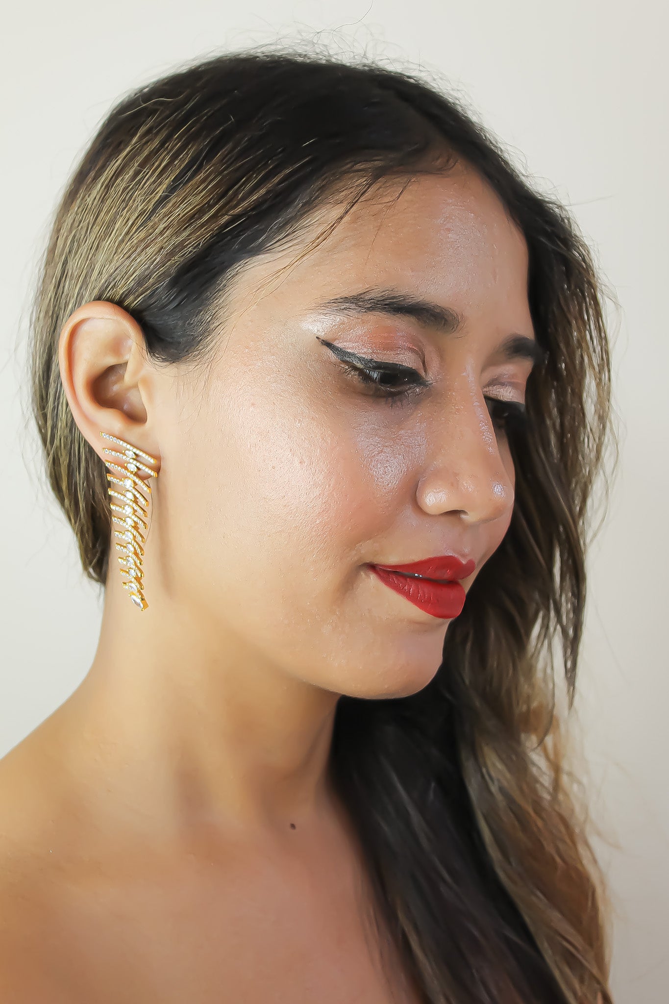 Elegant Fishbone Earrings in gold, silver, and rose-gold plating with zirconia stones, showcasing a modern design.