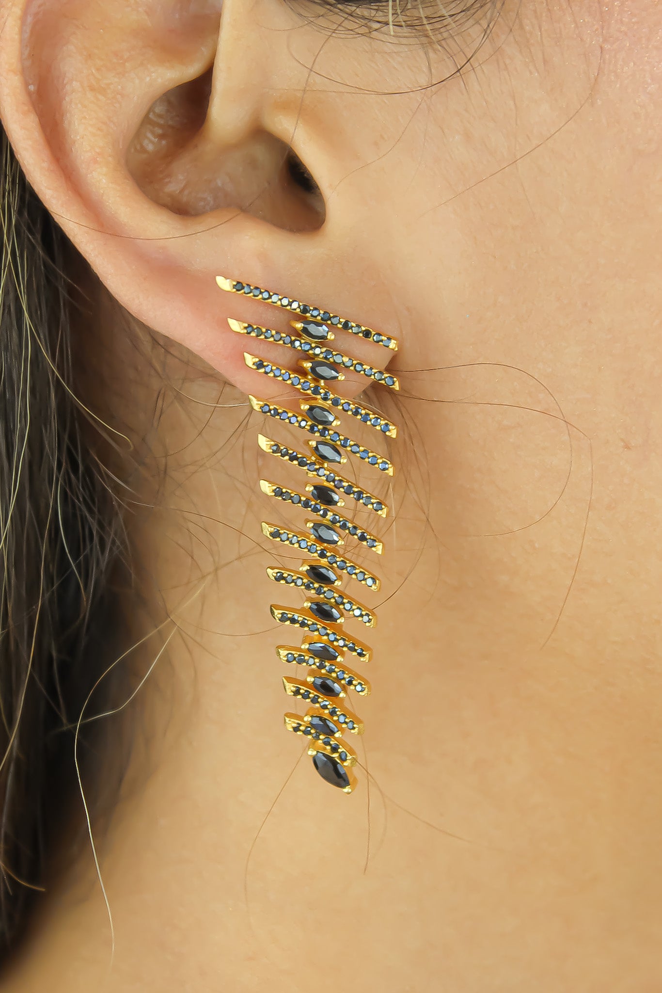 Elegant Fishbone Earrings in gold, silver, and rose-gold plating with zirconia stones, showcasing a modern design.