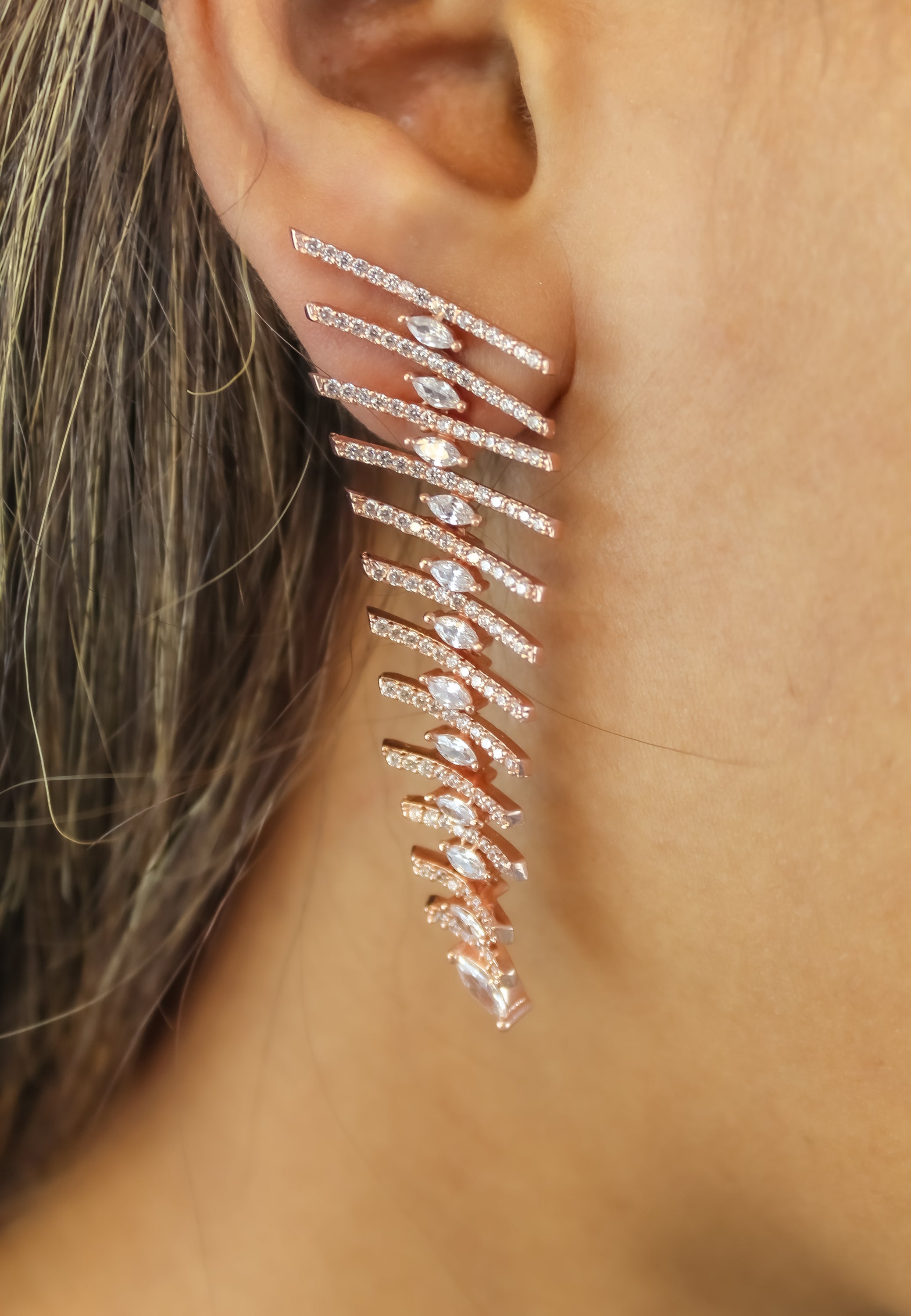 Elegant Fishbone Earrings in gold, silver, and rose-gold plating with zirconia stones, showcasing a modern design.