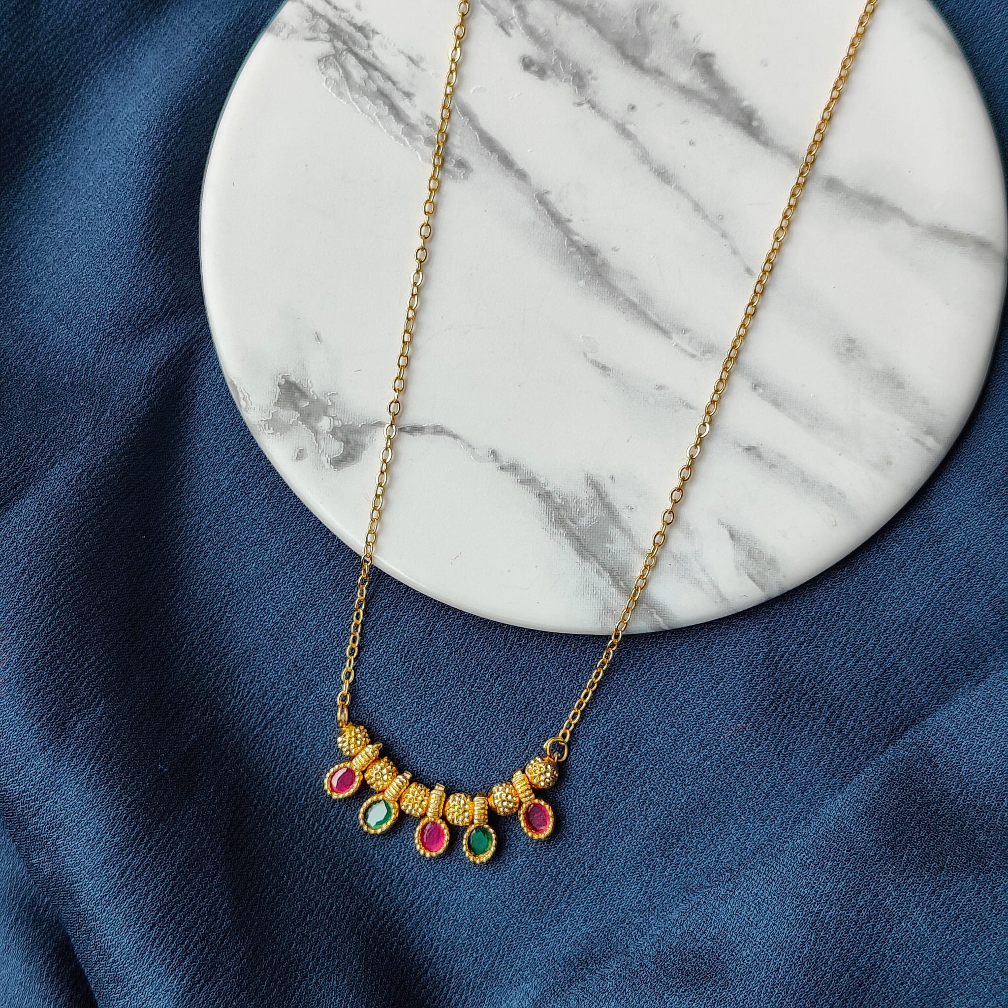 Five Stone Dangle Necklace featuring colorful stones on a gold brass chain, elegantly designed for modern women.