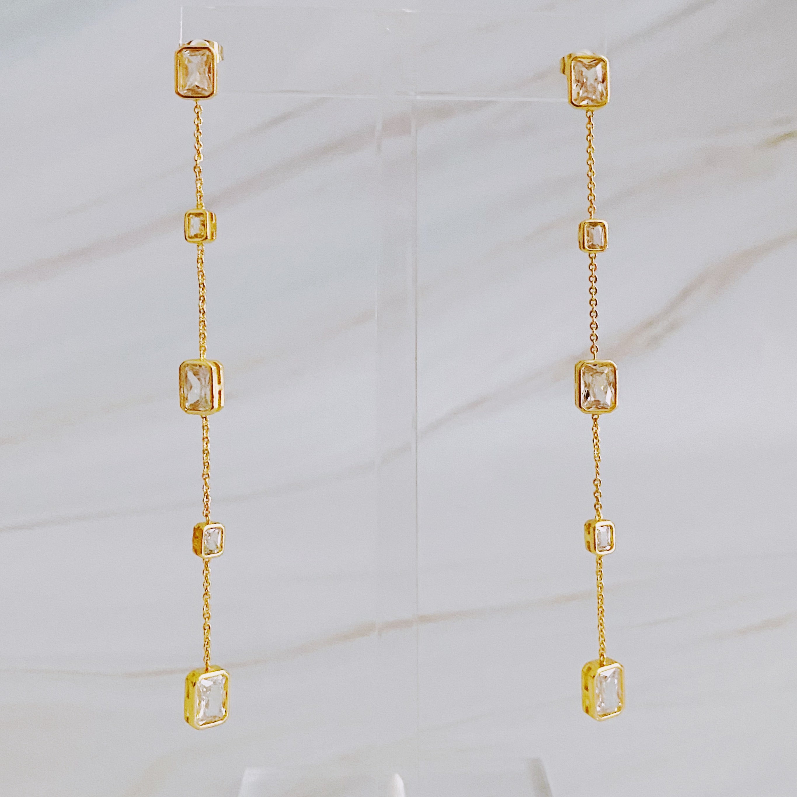 Elegant Five Stones Dangle Drop Earrings featuring sparkling cubic zirconia stones set in gold plated brass.