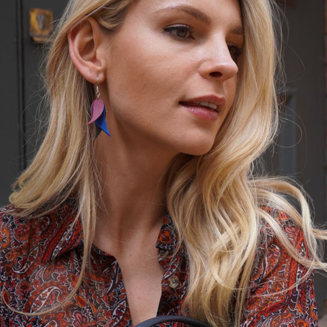 A pair of vibrant Flake Recycled Leather Earrings featuring a delicate leaf design, handcrafted from colorful leather offcuts.