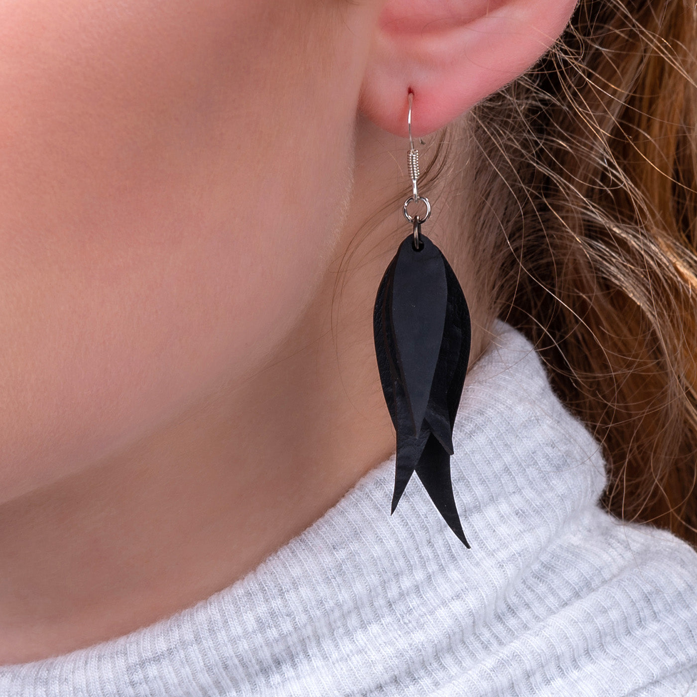 A pair of Flake Recycled Rubber Earrings showcasing unique patterns and textures, handcrafted from reclaimed tyre inner tubes.