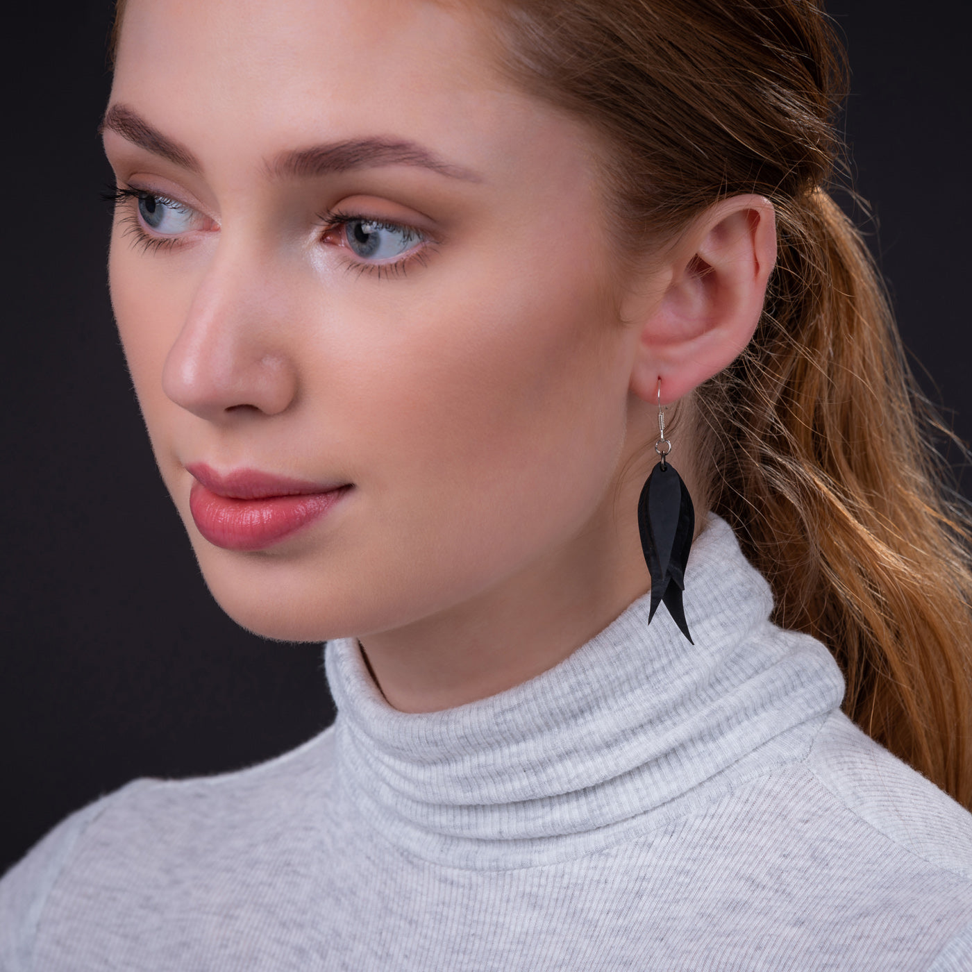 A pair of Flake Recycled Rubber Earrings showcasing unique patterns and textures, handcrafted from reclaimed tyre inner tubes.