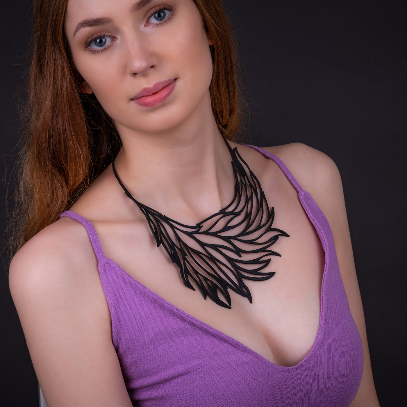 Flame Handmade Upcycle Statement Necklace made from reclaimed rubber, showcasing unique textures and patterns.