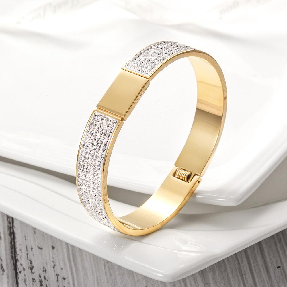 A luxurious FLAWLESS PAVÉ BANGLE made of 316L surgical stainless steel with 14K gold PVD plating, showcasing its elegant design.