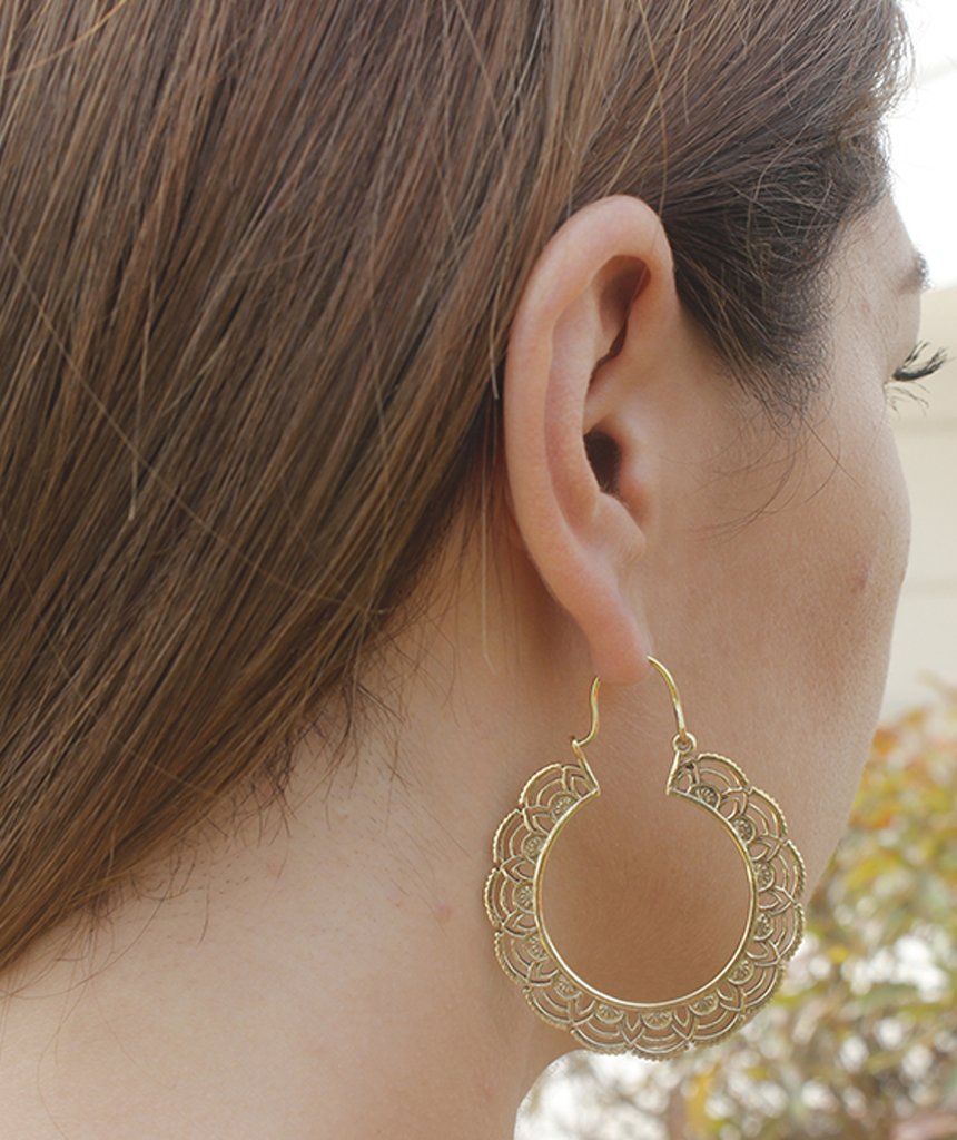 A pair of elegant floral hoop earrings featuring intricate etched designs, crafted from brass and silver-plated brass.