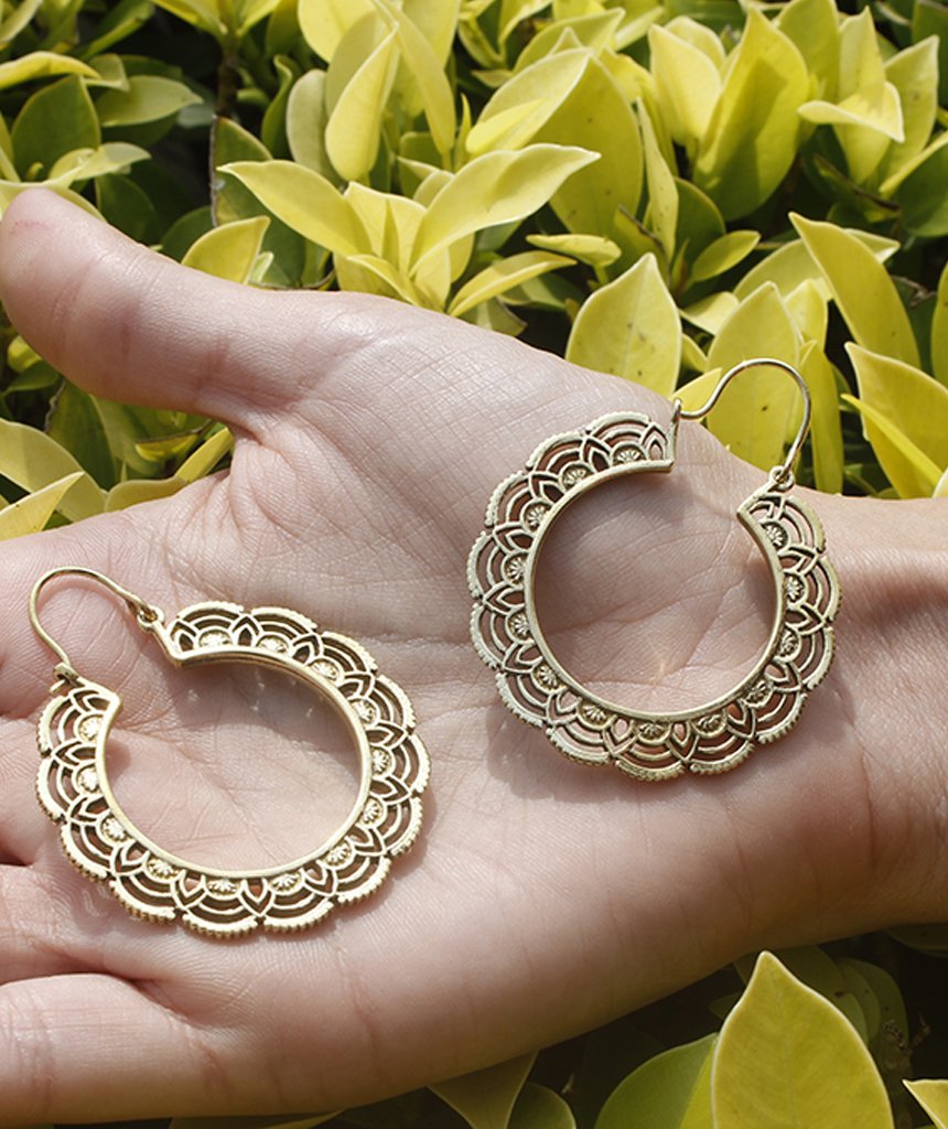 A pair of elegant floral hoop earrings featuring intricate etched designs, crafted from brass and silver-plated brass.