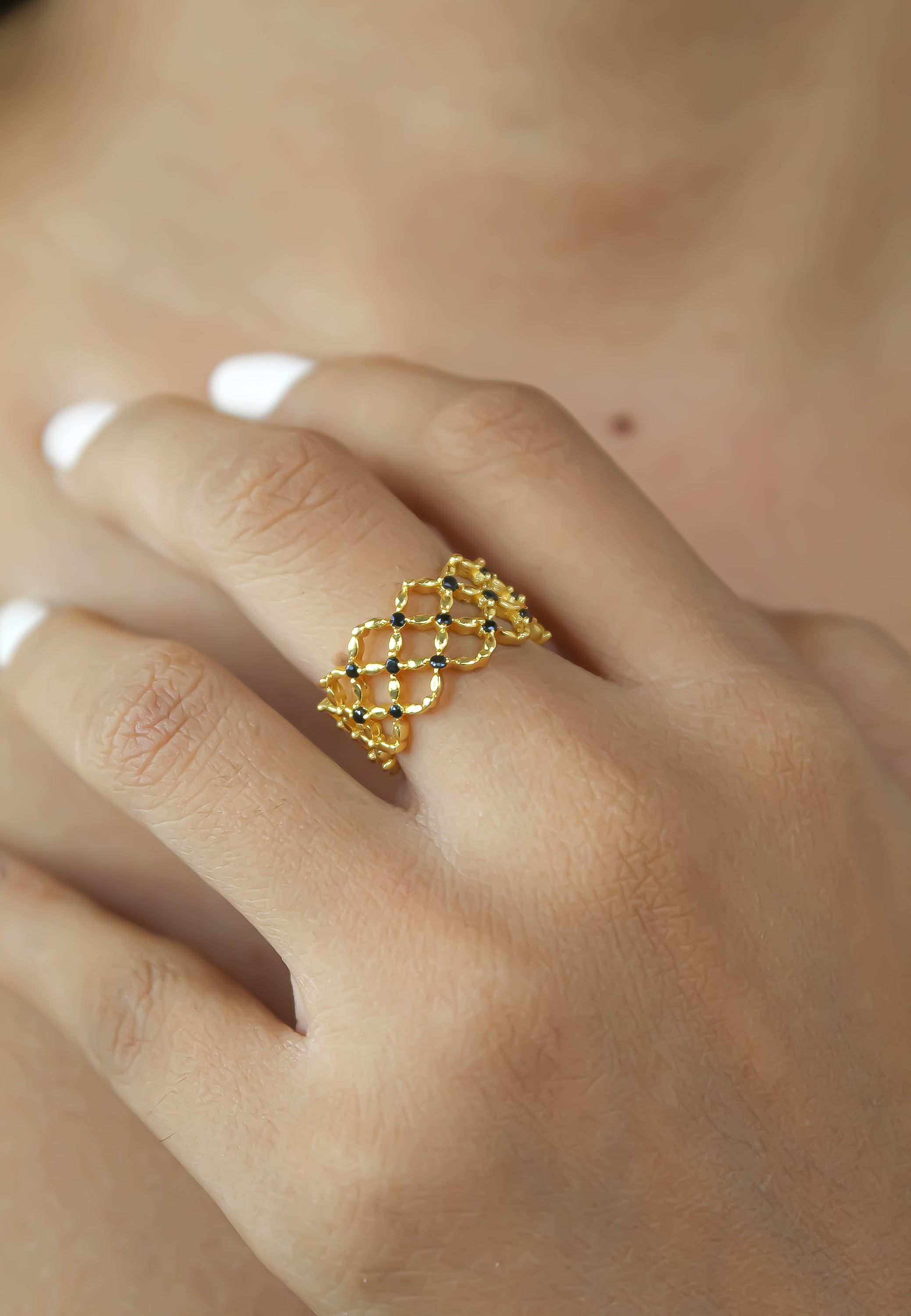 The Florence Ring featuring 18K gold plating and 13 round cut zirconia stones, adjustable size for comfort.