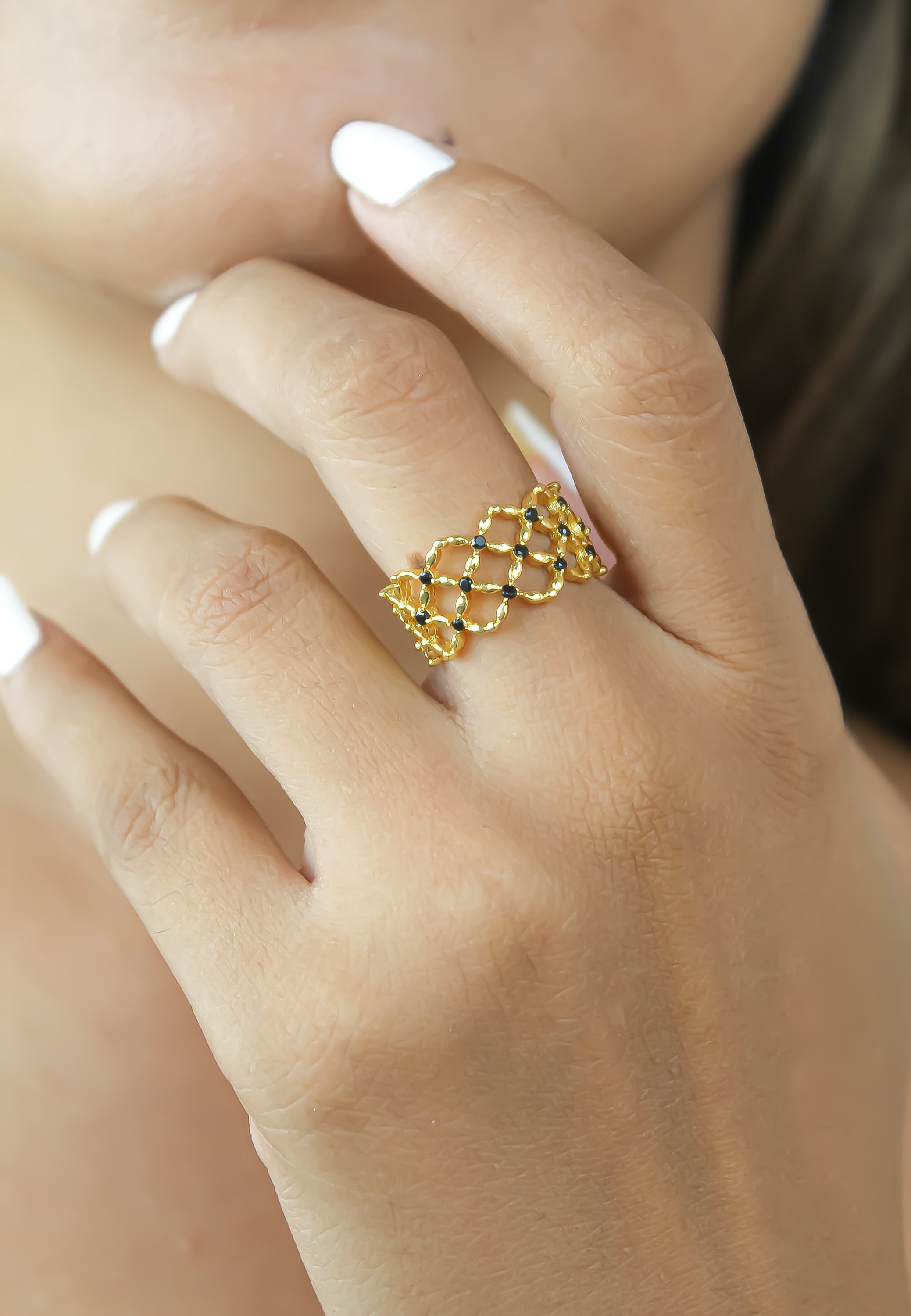 The Florence Ring featuring 18K gold plating and 13 round cut zirconia stones, adjustable size for comfort.