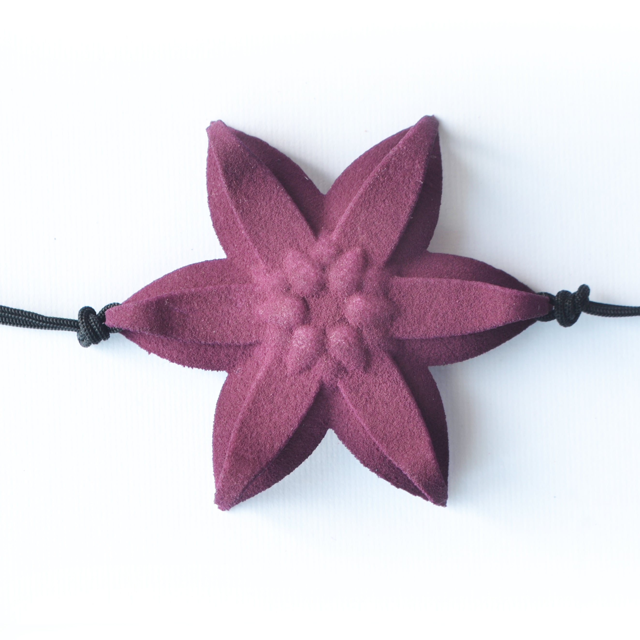 A beautiful Dahlia Flower Bracelet featuring a large flower design made of ultra-light nylon and sterling silver accents.