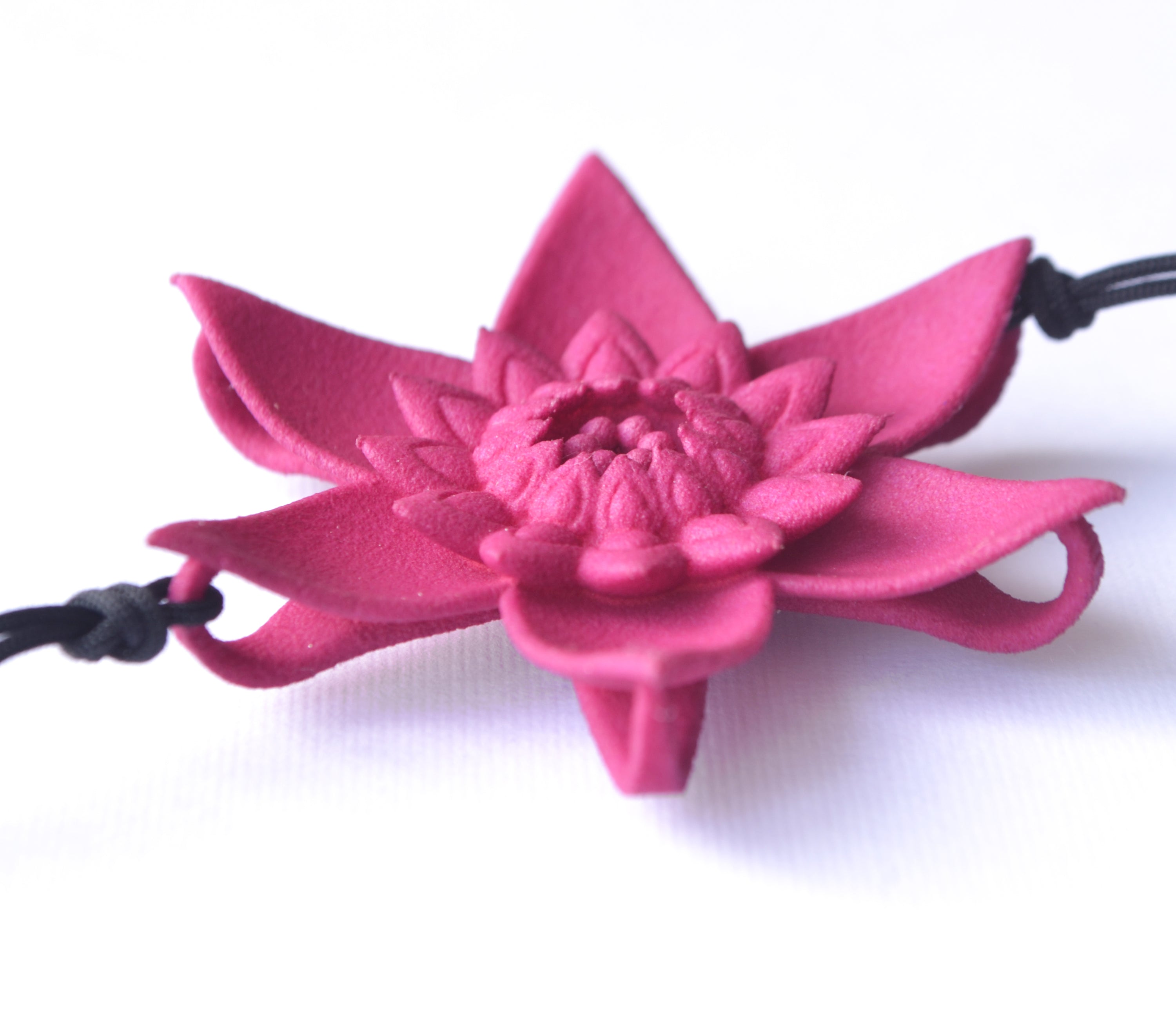 A beautiful Dahlia Flower Bracelet featuring a large flower design made of ultra-light nylon and sterling silver accents.