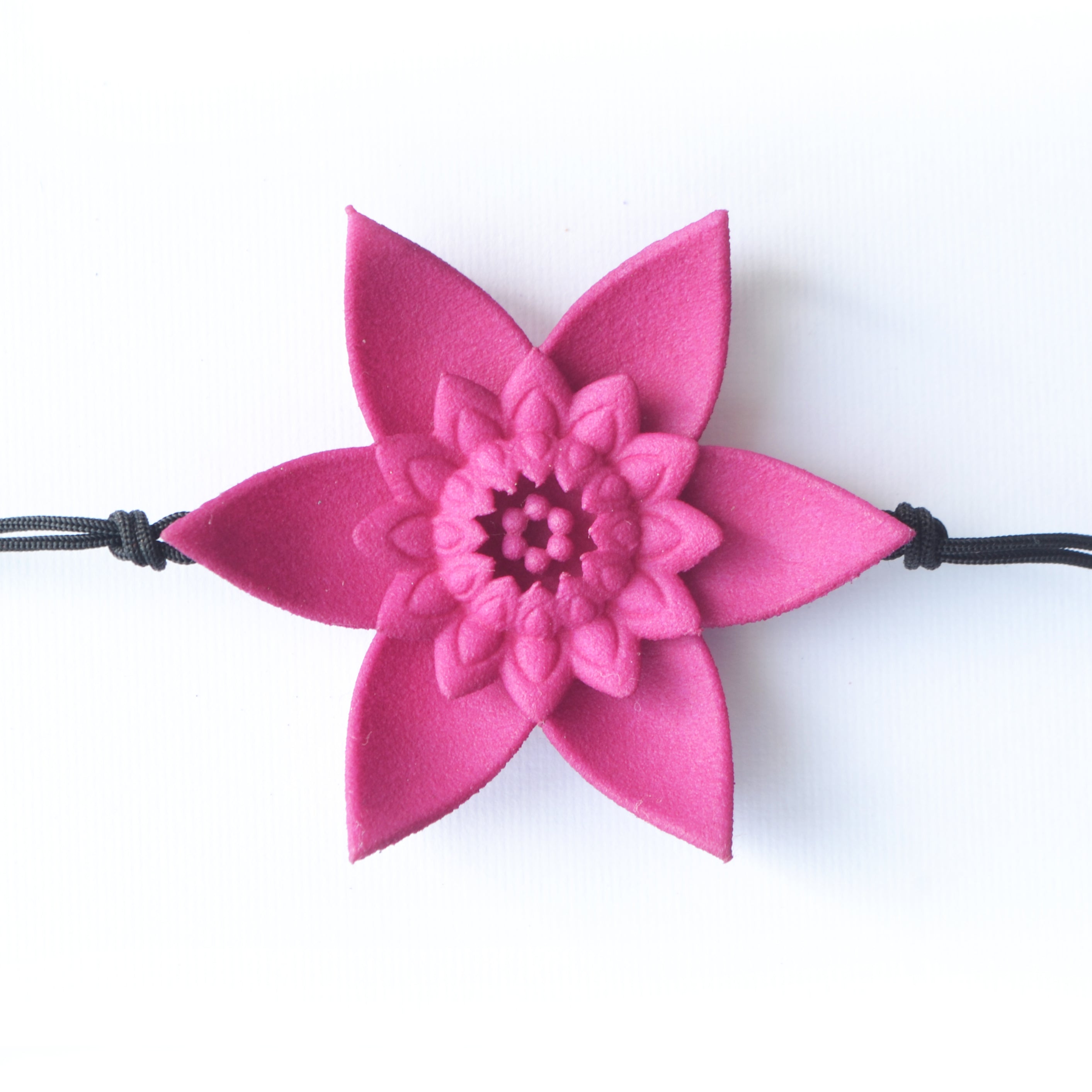 A beautiful Dahlia Flower Bracelet featuring a large flower design made of ultra-light nylon and sterling silver accents.