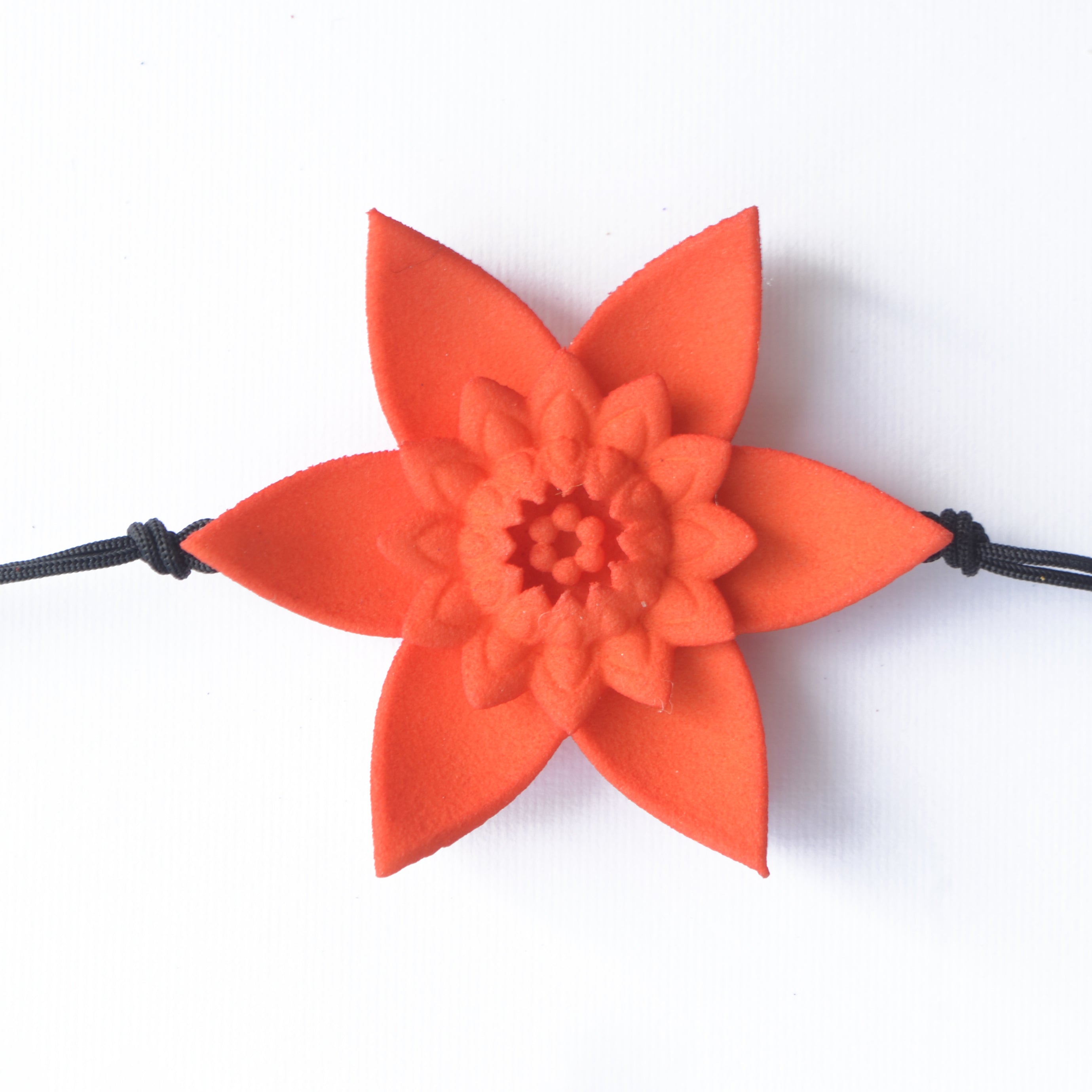 A beautiful Dahlia Flower Bracelet featuring a large flower design made of ultra-light nylon and sterling silver accents.