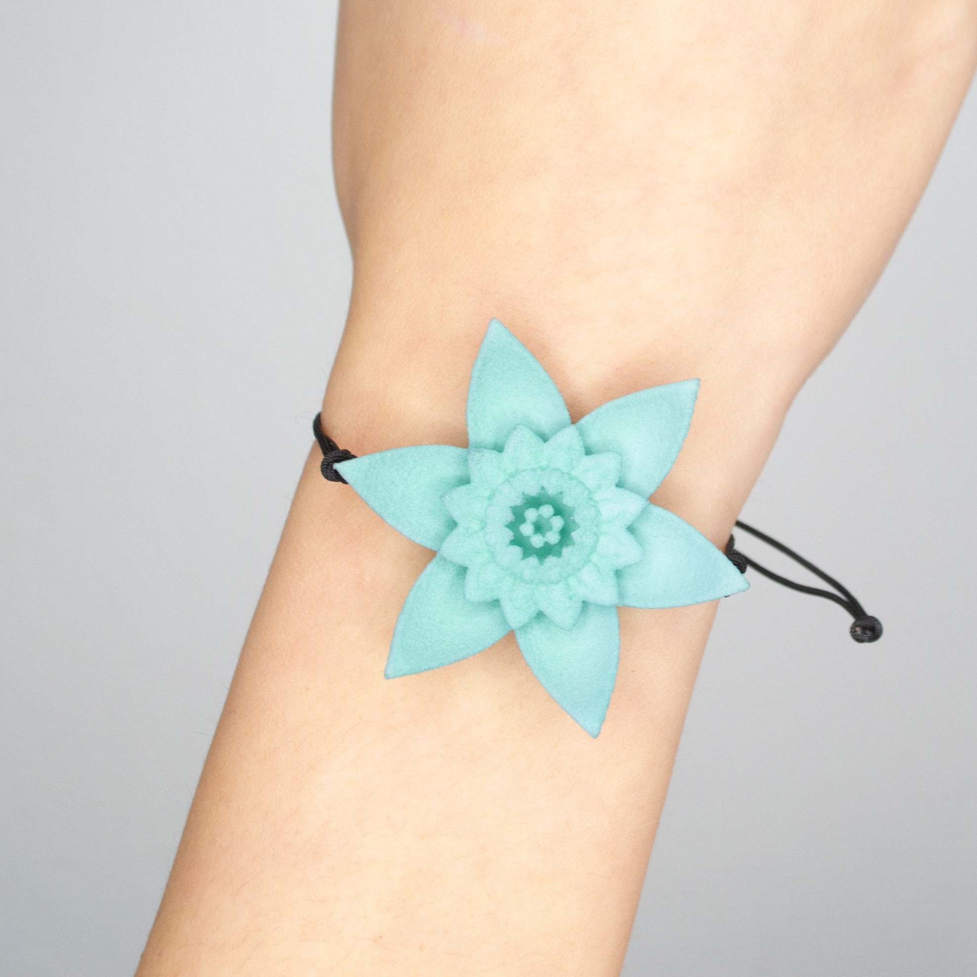 A beautiful Dahlia Flower Bracelet featuring a large flower design made of ultra-light nylon and sterling silver accents.