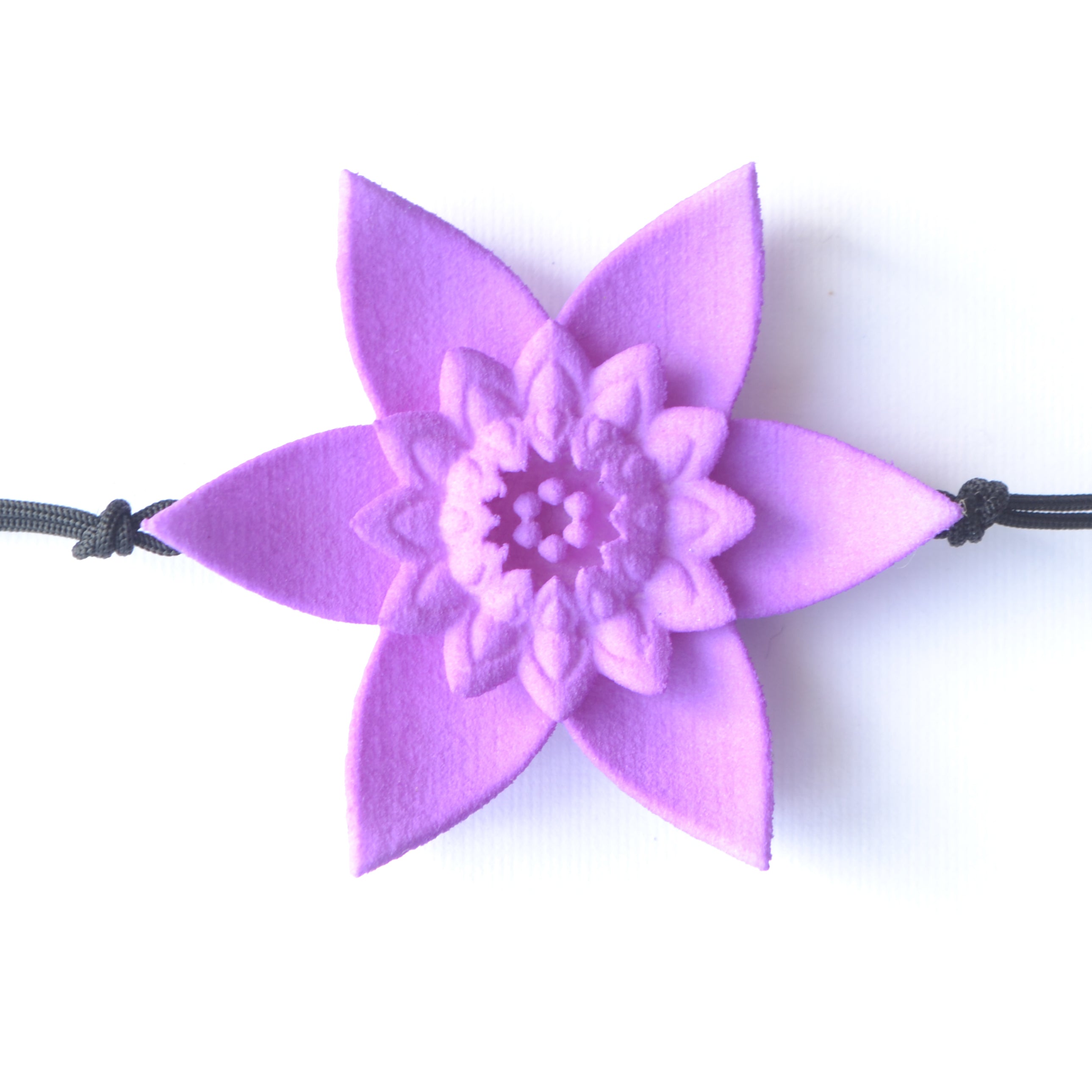 A beautiful Dahlia Flower Bracelet featuring a large flower design made of ultra-light nylon and sterling silver accents.