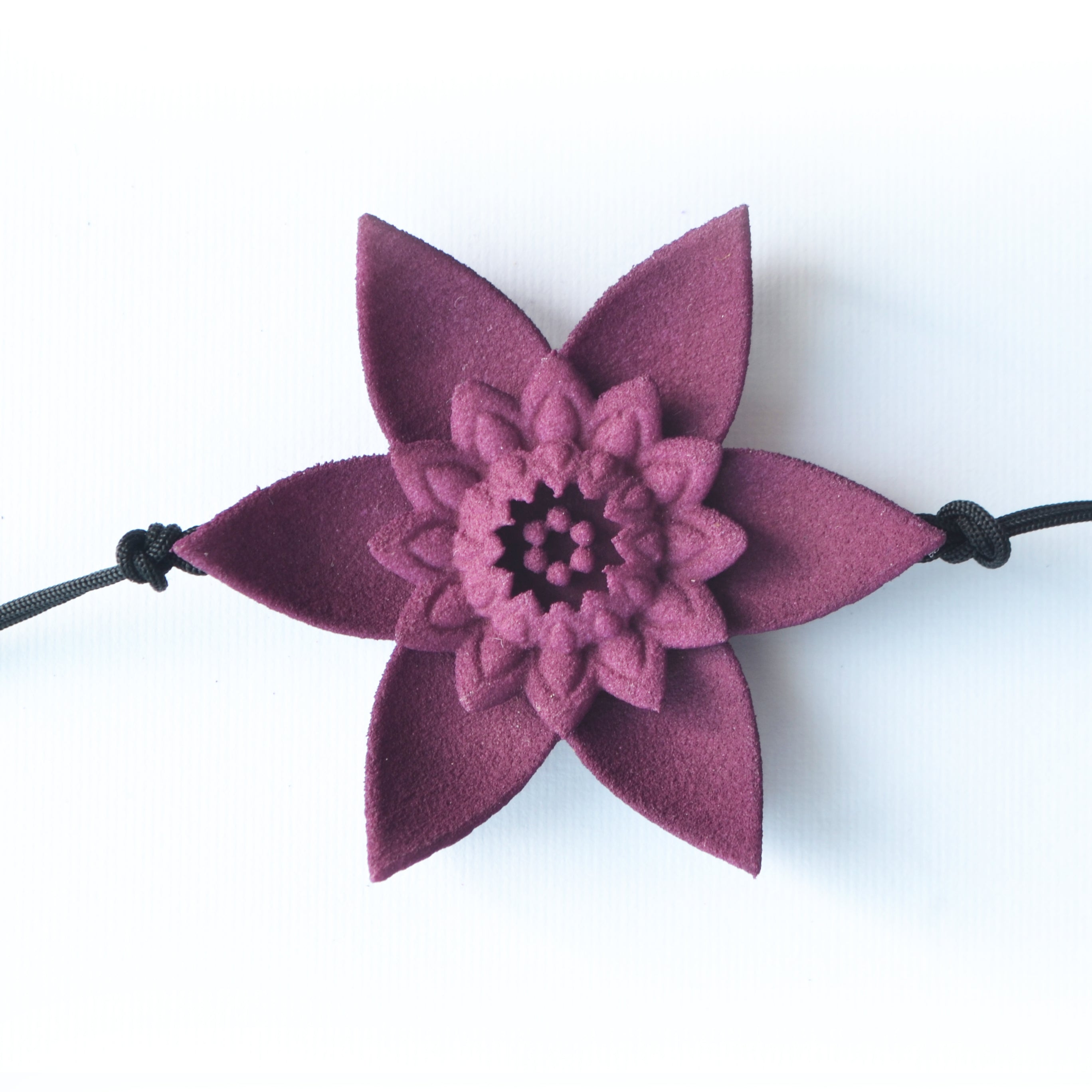 A beautiful Dahlia Flower Bracelet featuring a large flower design made of ultra-light nylon and sterling silver accents.