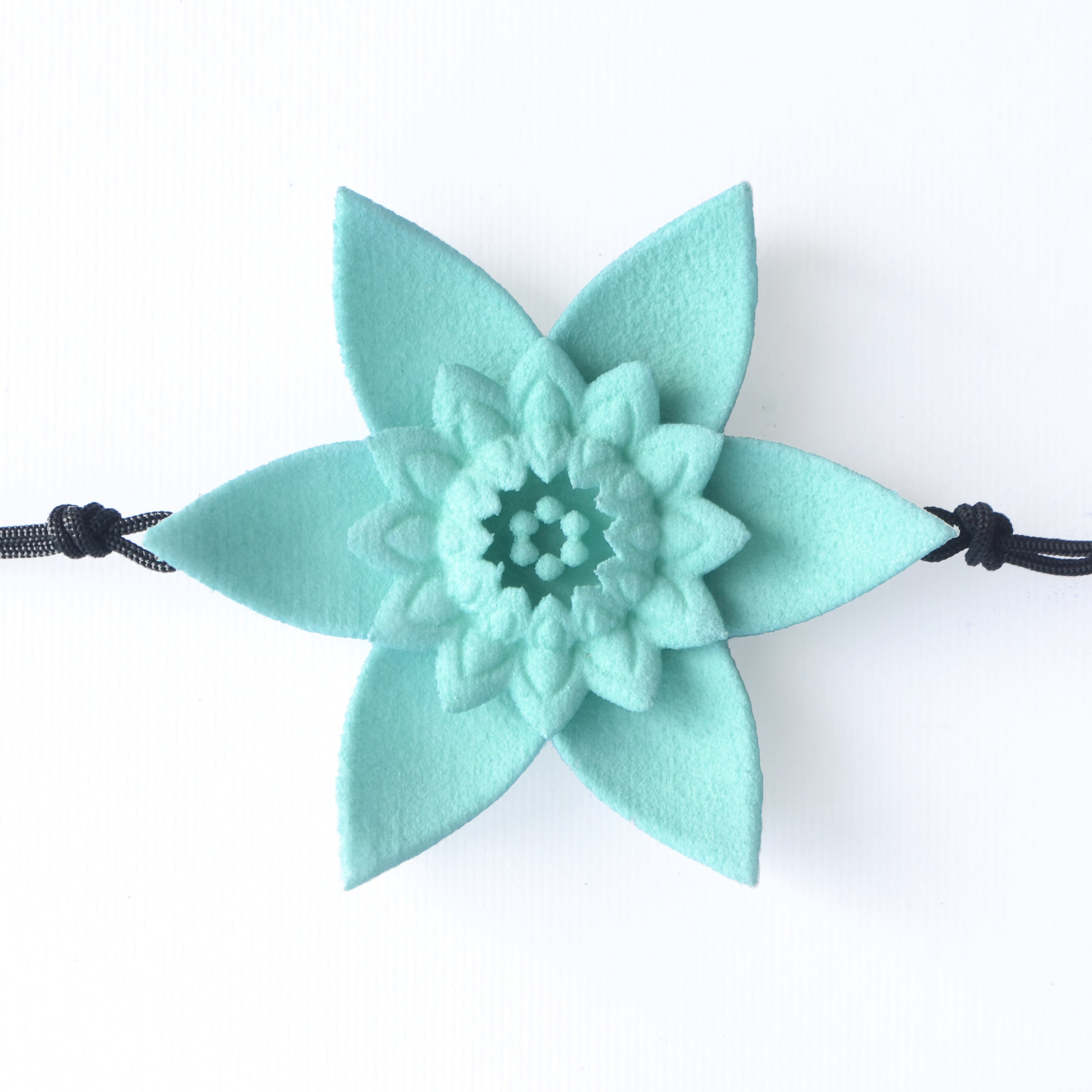 A beautiful Dahlia Flower Bracelet featuring a large flower design made of ultra-light nylon and sterling silver accents.