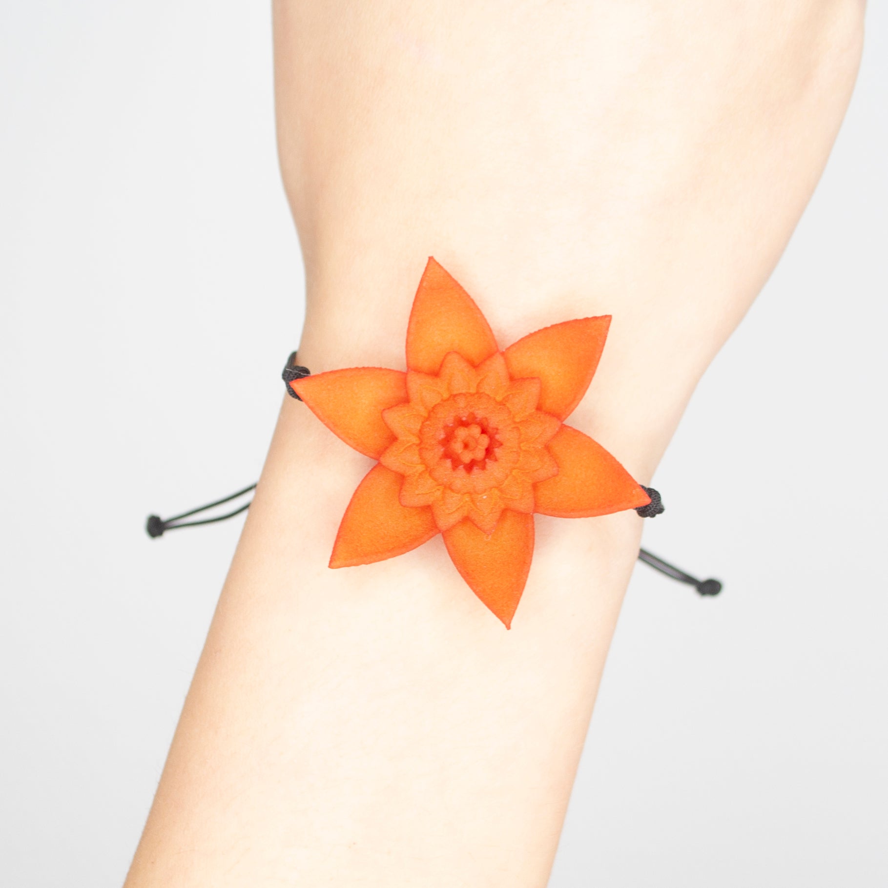 A beautiful Dahlia Flower Bracelet featuring a large flower design made of ultra-light nylon and sterling silver accents.