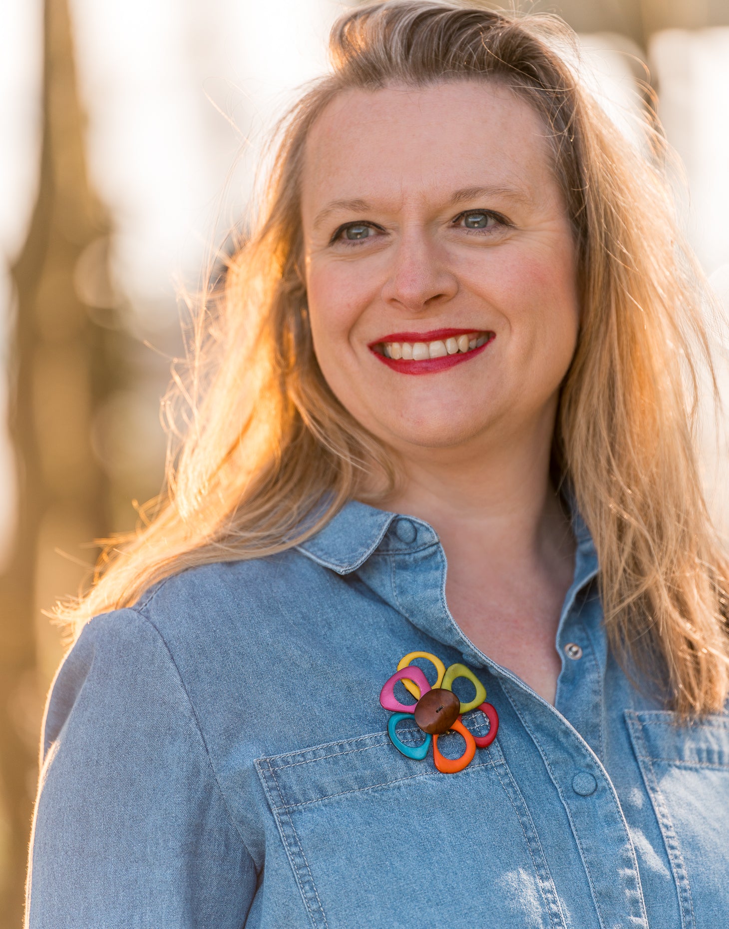 A delicate flower brooch shaped like a daisy, made from slices of tagua, featuring a magnetic backing for easy attachment.