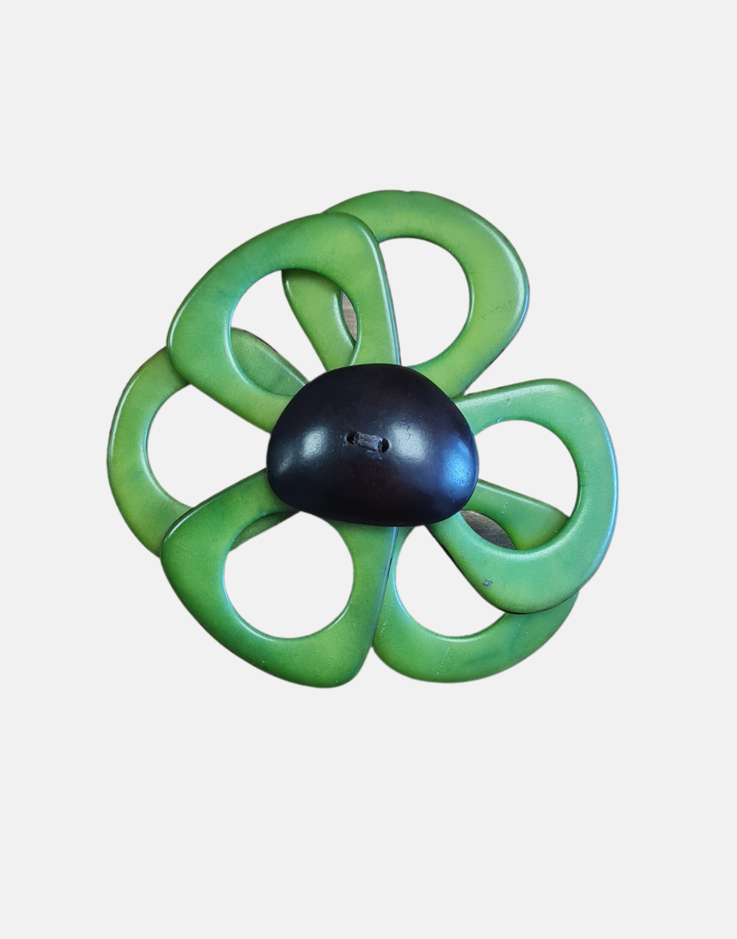 A delicate flower brooch shaped like a daisy, made from slices of tagua, featuring a magnetic backing for easy attachment.