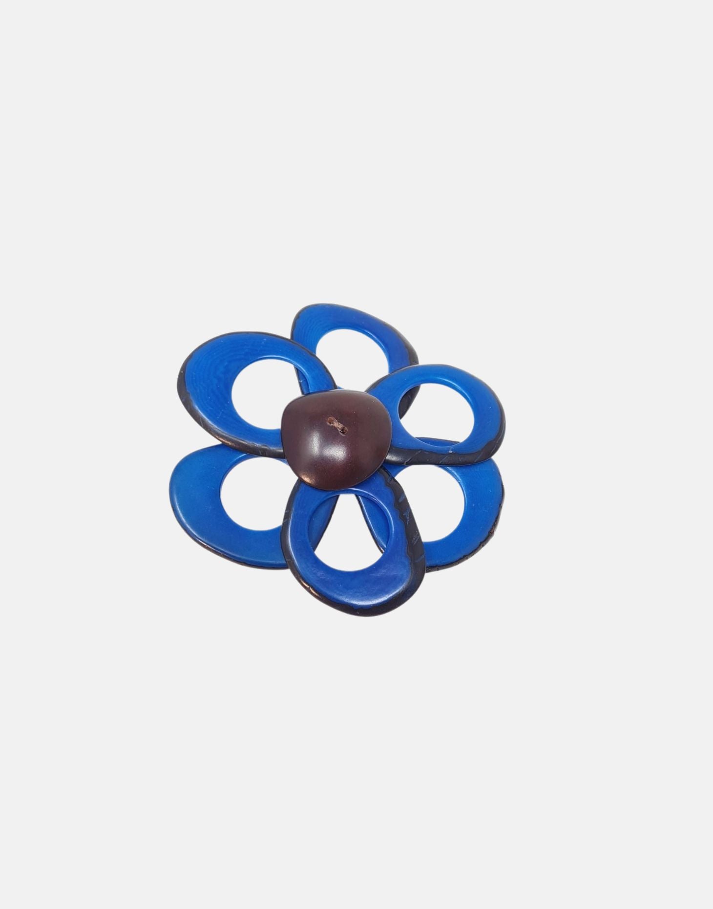 A delicate flower brooch shaped like a daisy, made from slices of tagua, featuring a magnetic backing for easy attachment.