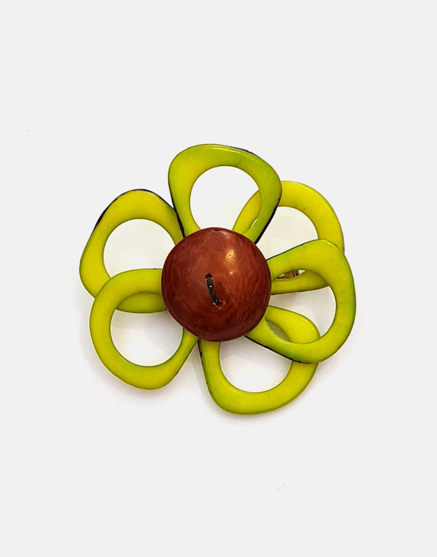 A delicate flower brooch designed as a daisy, made from slices of tagua, showcasing natural variations in color and texture.