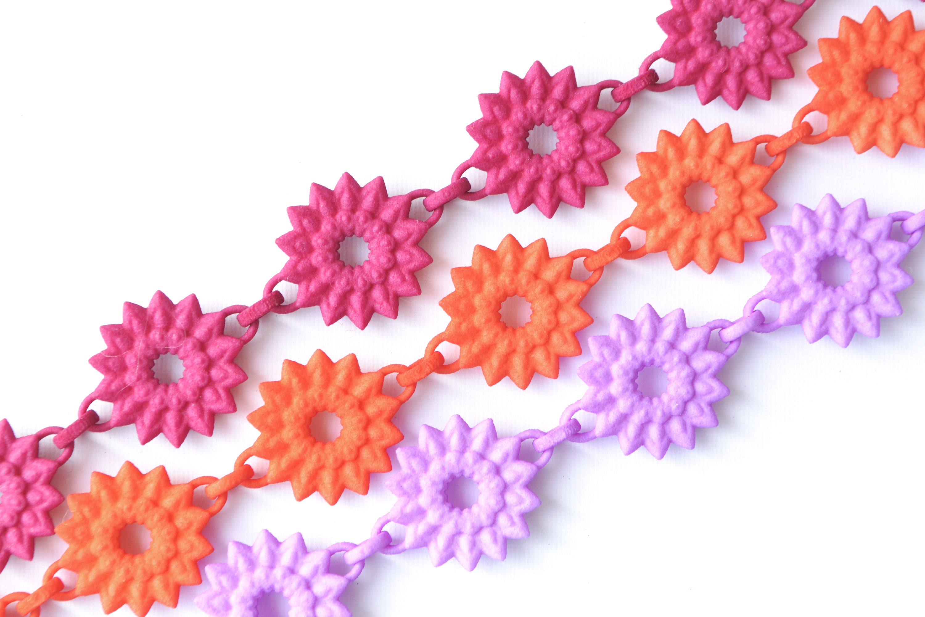 A vibrant Flower Chain Bracelet featuring delicate dahlia flowers, crafted from lightweight nylon material with a toggle clasp.