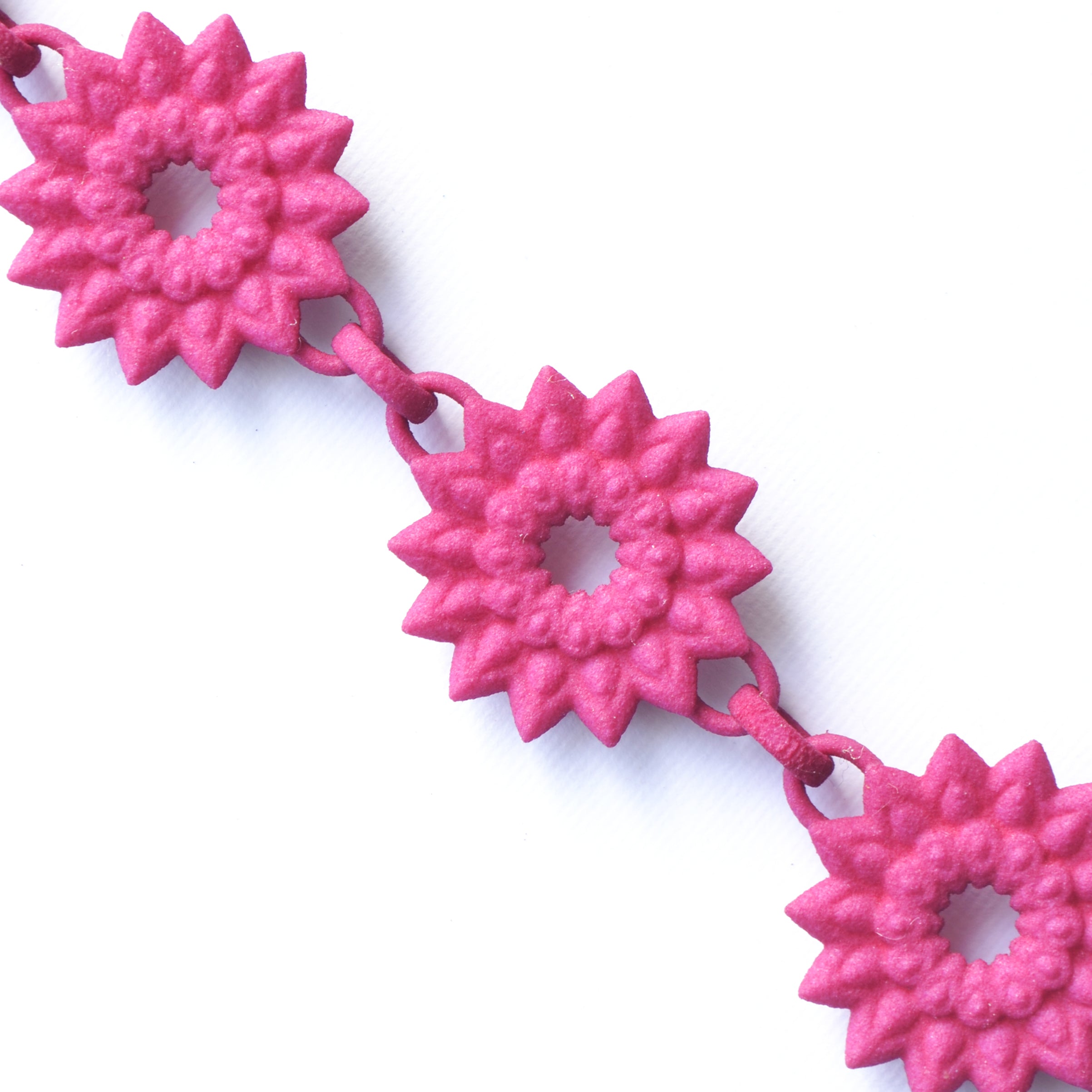 A vibrant Flower Chain Bracelet featuring delicate dahlia flowers, crafted from lightweight nylon material with a toggle clasp.