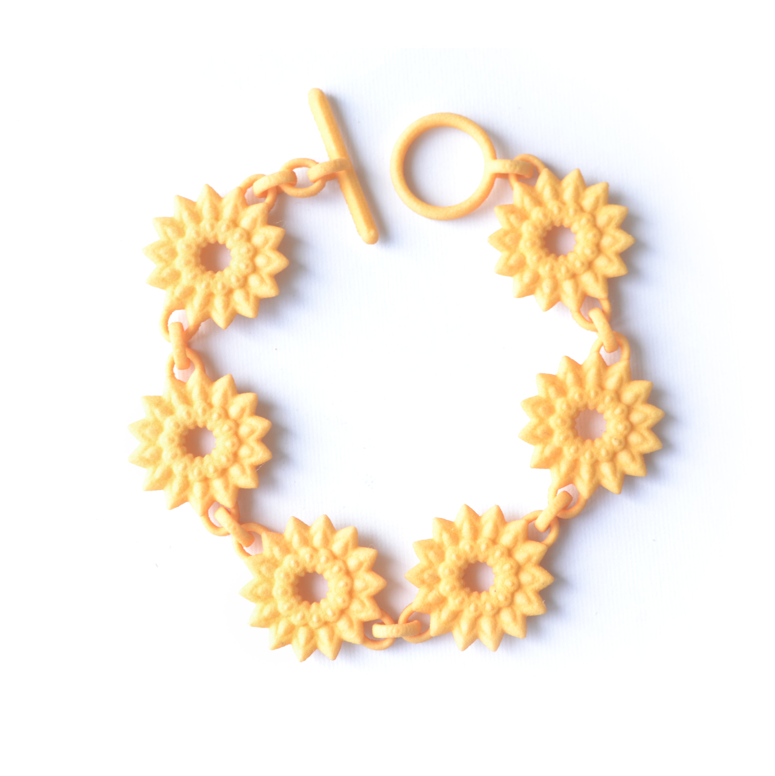 A vibrant Flower Chain Bracelet featuring delicate dahlia flowers, crafted from lightweight nylon material with a toggle clasp.