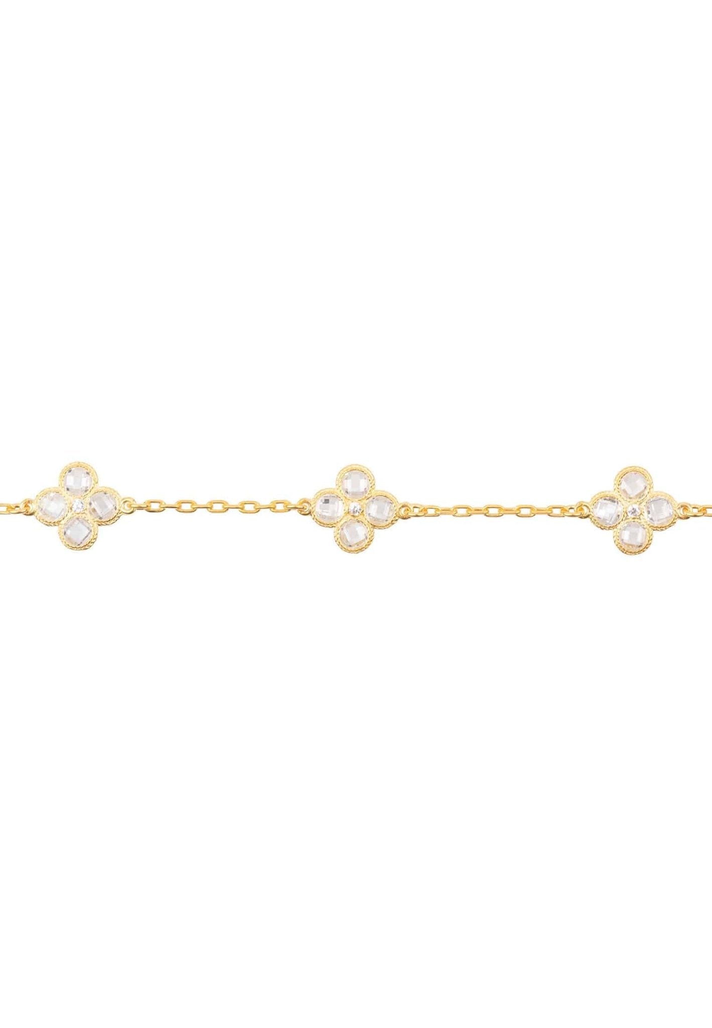 Flower Clover Triple Bracelet in gold with three floral motifs and white zirconia, showcasing a delicate chain and adjustable length.