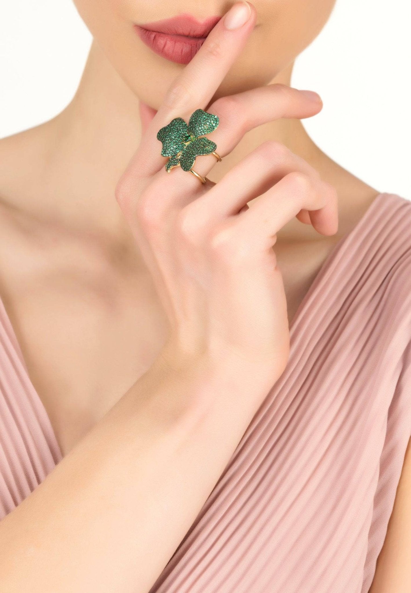 Elegant Flower Cocktail Ring in Gold featuring a large Emerald Green cubic zirconia centerpiece and adjustable metallic bands.