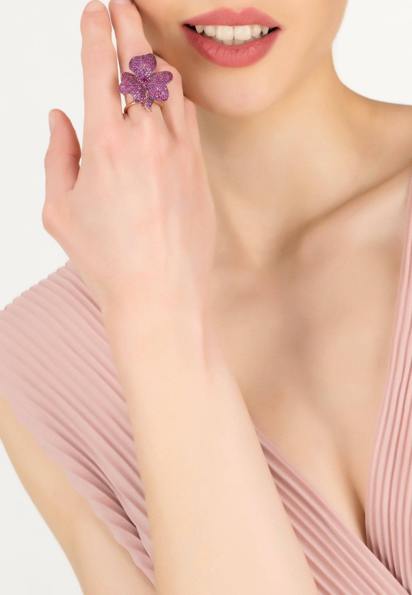 Flower Cocktail Ring in Rosegold featuring a large flower motif adorned with ruby cubic zirconia on adjustable metallic bands.