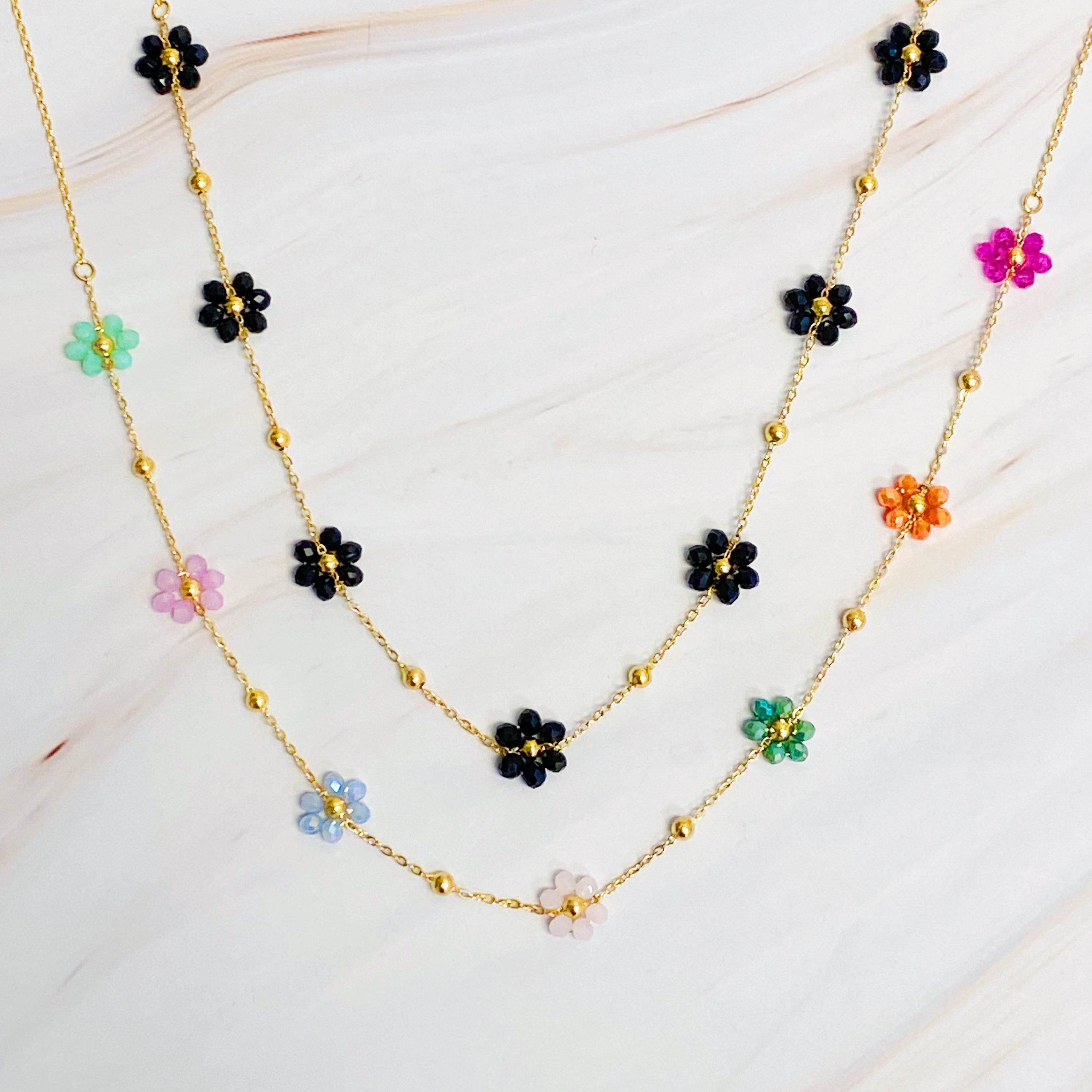 Flower Field Romance Beaded Necklace featuring colorful flowers on a dainty gold chain, perfect for layering.