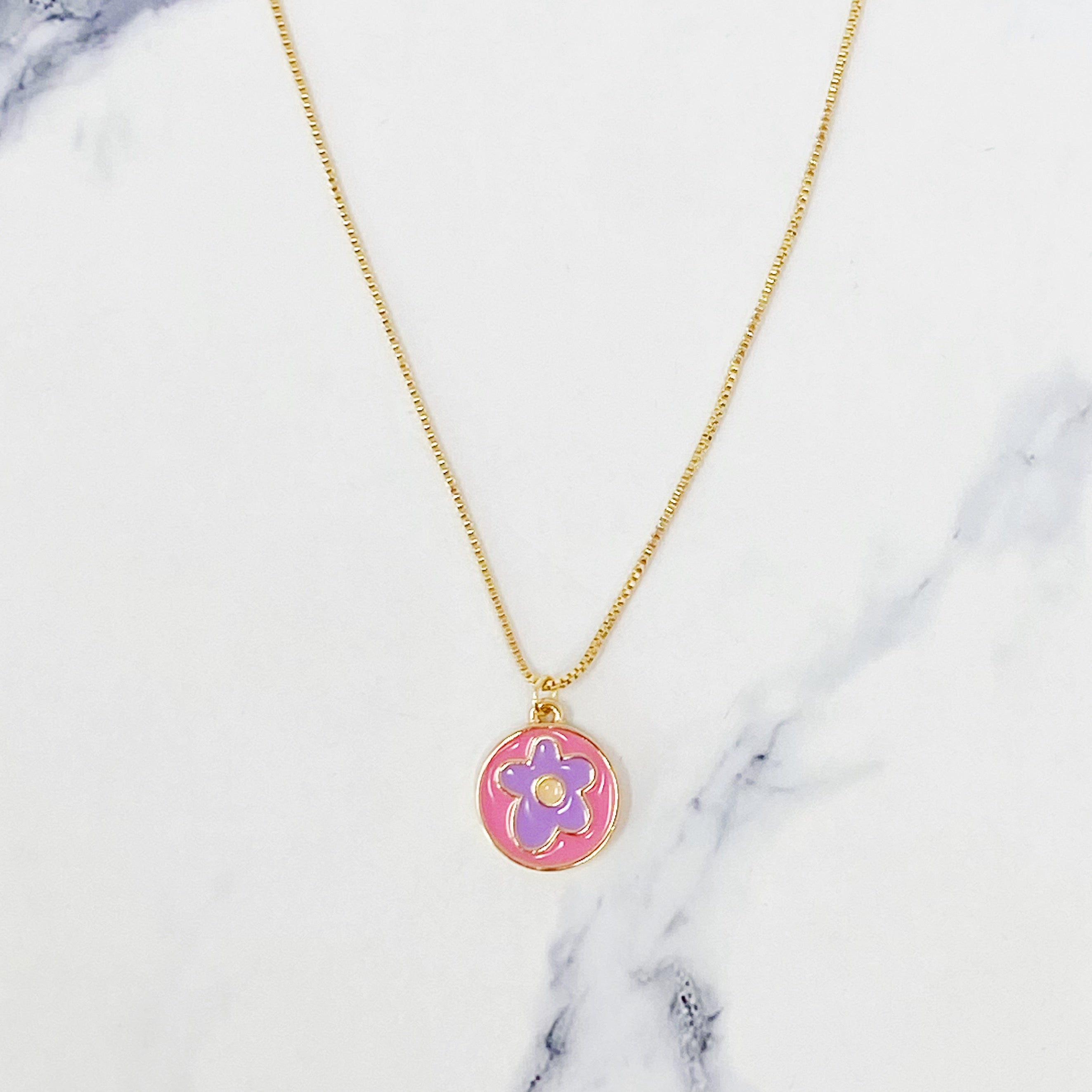 A delicate Flower Lover Necklace featuring a colorful flower pendant on a gold plated chain.