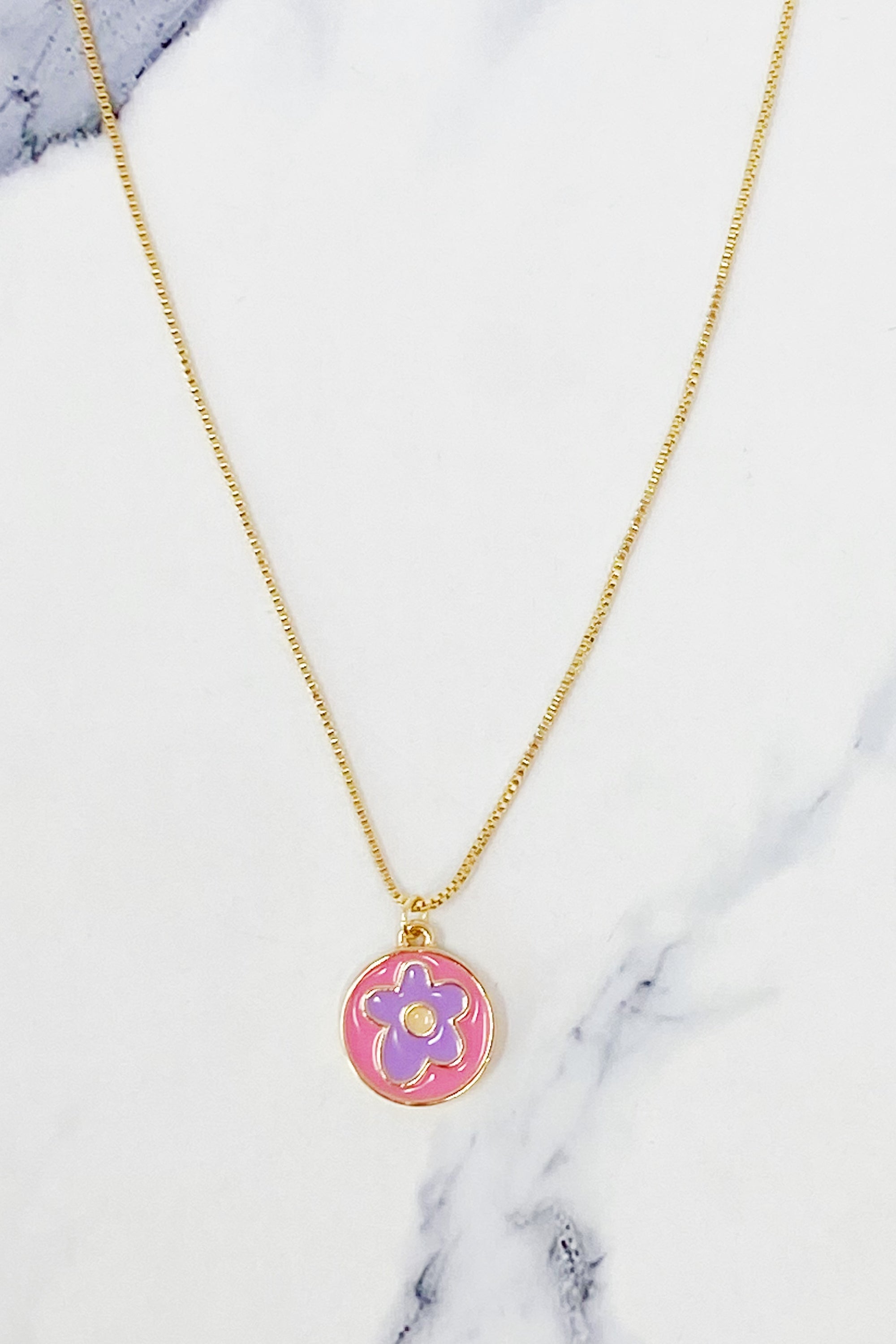 A delicate Flower Lover Necklace featuring a colorful flower pendant on a gold plated chain.