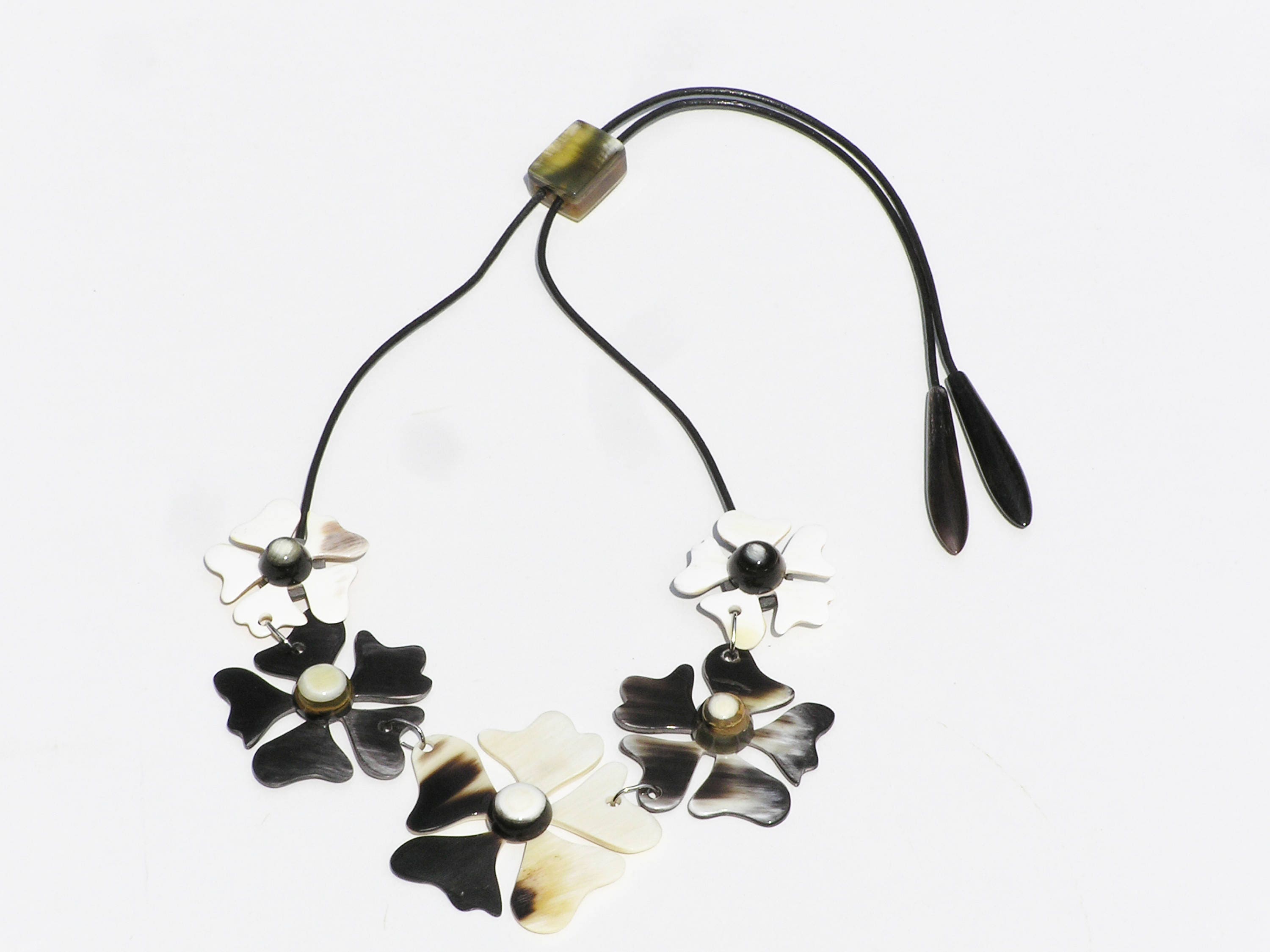 A beautifully crafted flower necklace for women made from natural buffalo horn, featuring intricate floral designs and a leather cord.