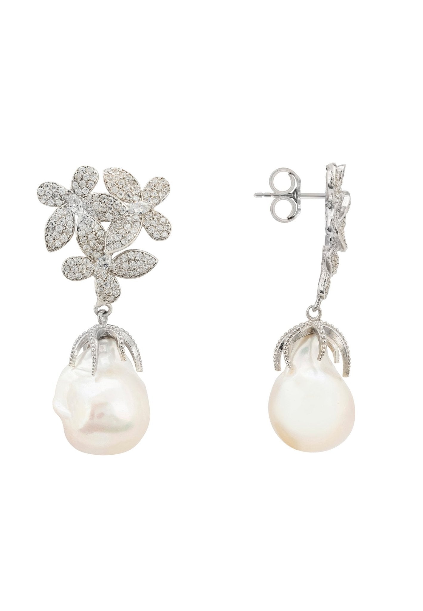 A pair of elegant silver earrings featuring floral designs with cubic zirconia and dangling baroque pearls, showcasing sophistication and charm.