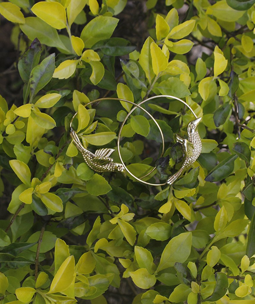 A pair of stunning Flying Bird Statement Earrings in brass with intricate hand-carved designs, showcasing a shiny finish, perfect for festivals.