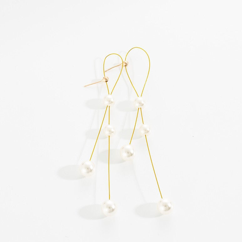 Elegant Folded Long Tassel Earrings adorned with pearls, showcasing a stylish design perfect for any occasion.